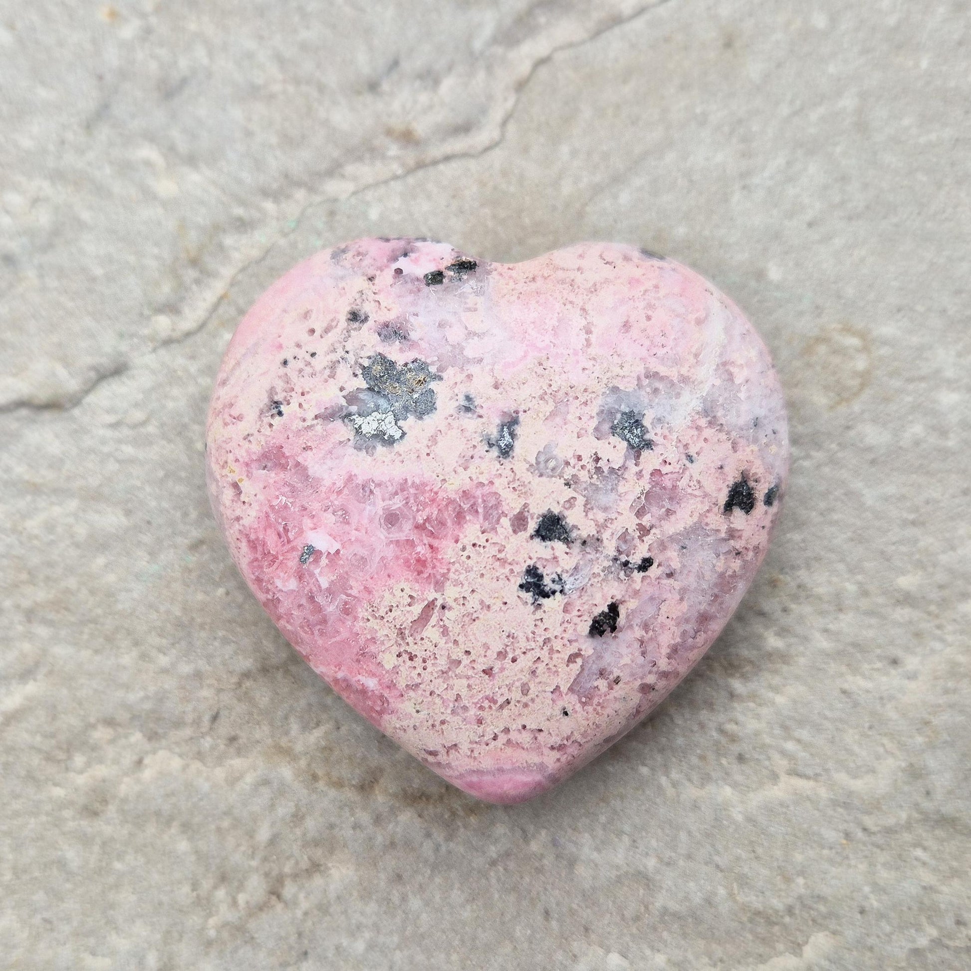 Pink Rhodonite Heart – Encourages love, forgiveness, and emotional balance while supporting personal growth, compassion, and healing. 