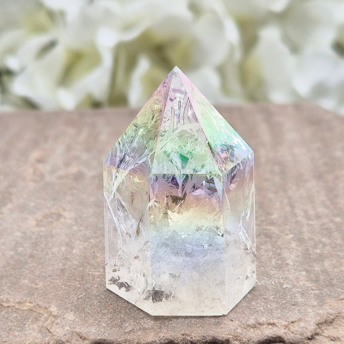 Aura Fire & Ice Quartz point with radiant rainbow flashes. Uplifting, self-cleansing crystal for meditation, intention and higher connection.