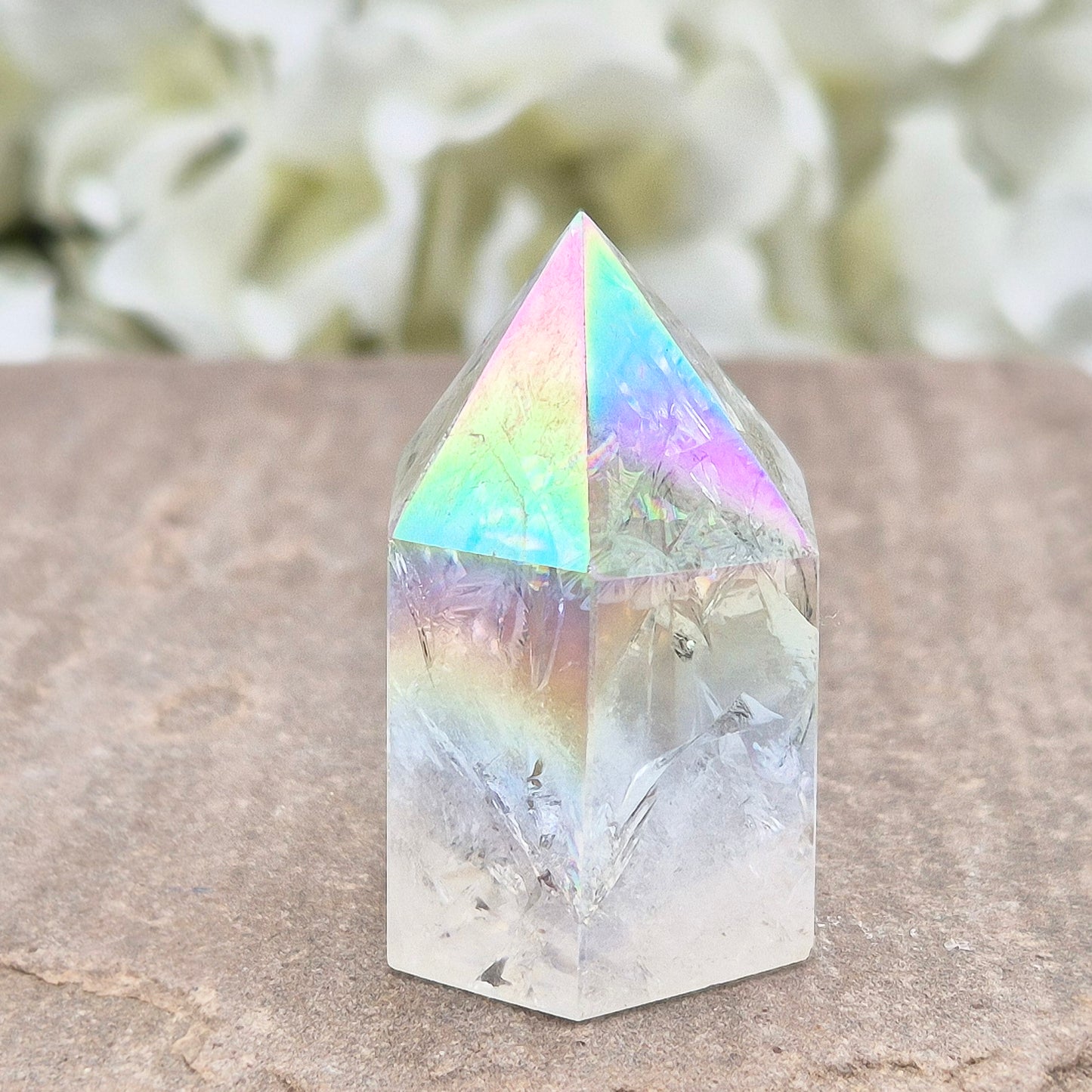 Aura Fire & Ice Quartz point with radiant rainbow flashes. Uplifting, self-cleansing crystal for meditation, intention and higher connection.