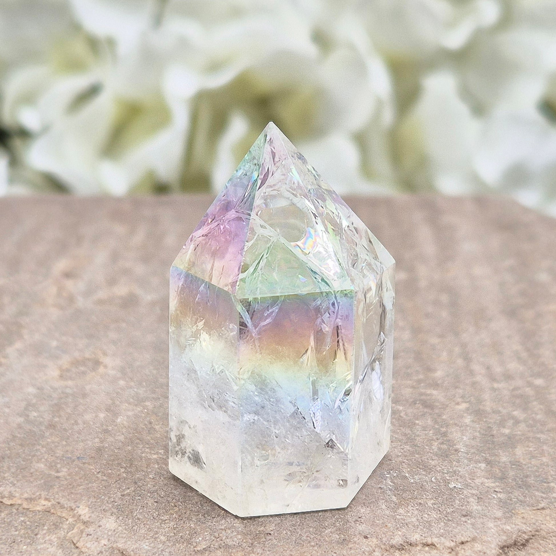 Aura Fire & Ice Quartz point with radiant rainbow flashes. Uplifting, self-cleansing crystal for meditation, intention and higher connection.