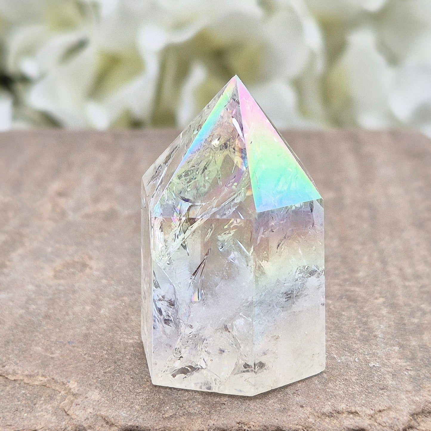 Aura Fire & Ice Quartz point with radiant rainbow flashes. Uplifting, self-cleansing crystal for meditation, intention and higher connection.