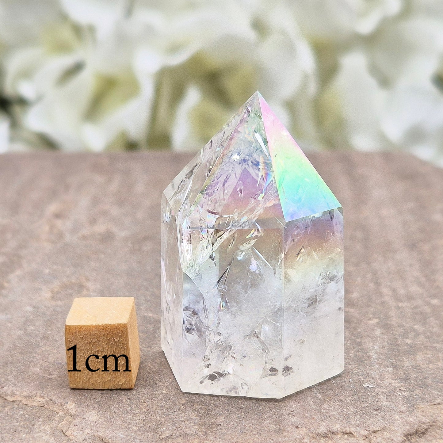 Aura Fire & Ice Quartz point with radiant rainbow flashes. Uplifting, self-cleansing crystal for meditation, intention and higher connection.