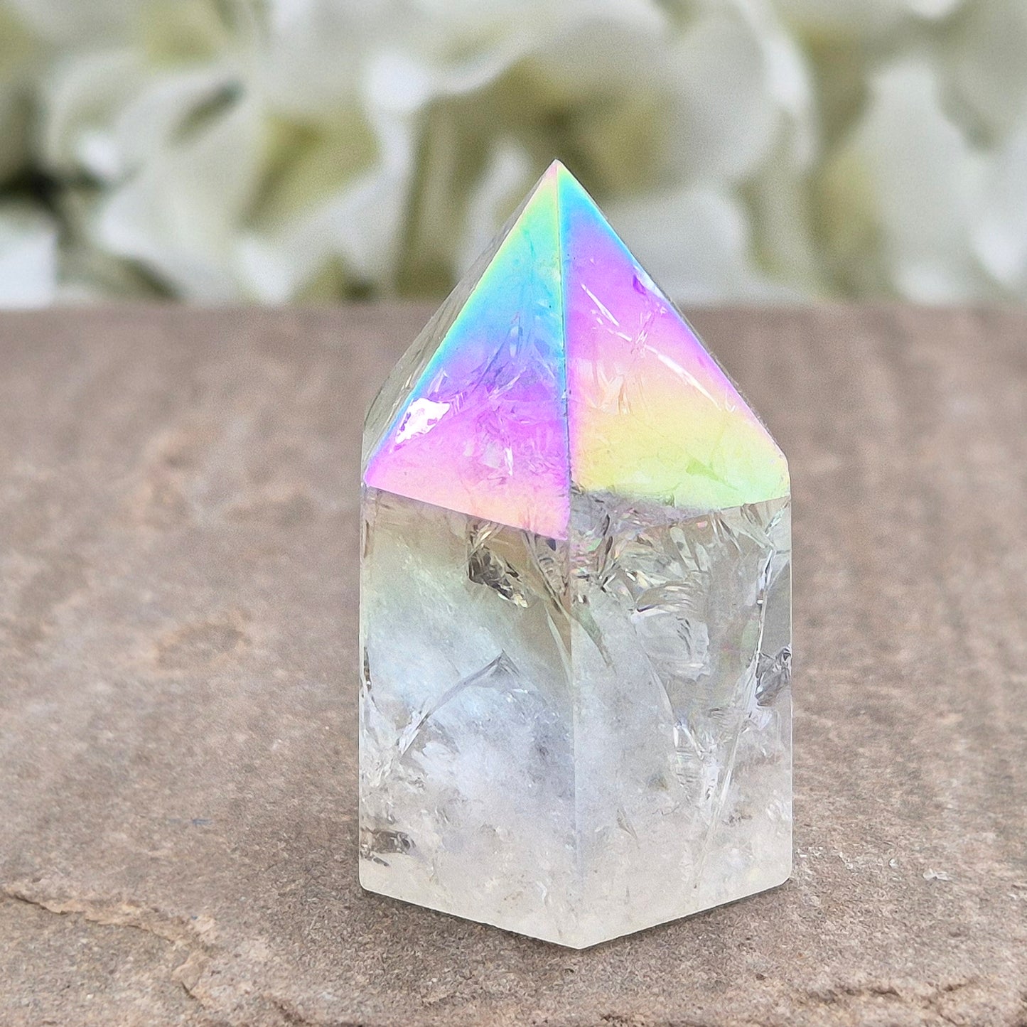 Aura Fire & Ice Quartz point with radiant rainbow flashes. Uplifting, self-cleansing crystal for meditation, intention and higher connection.
