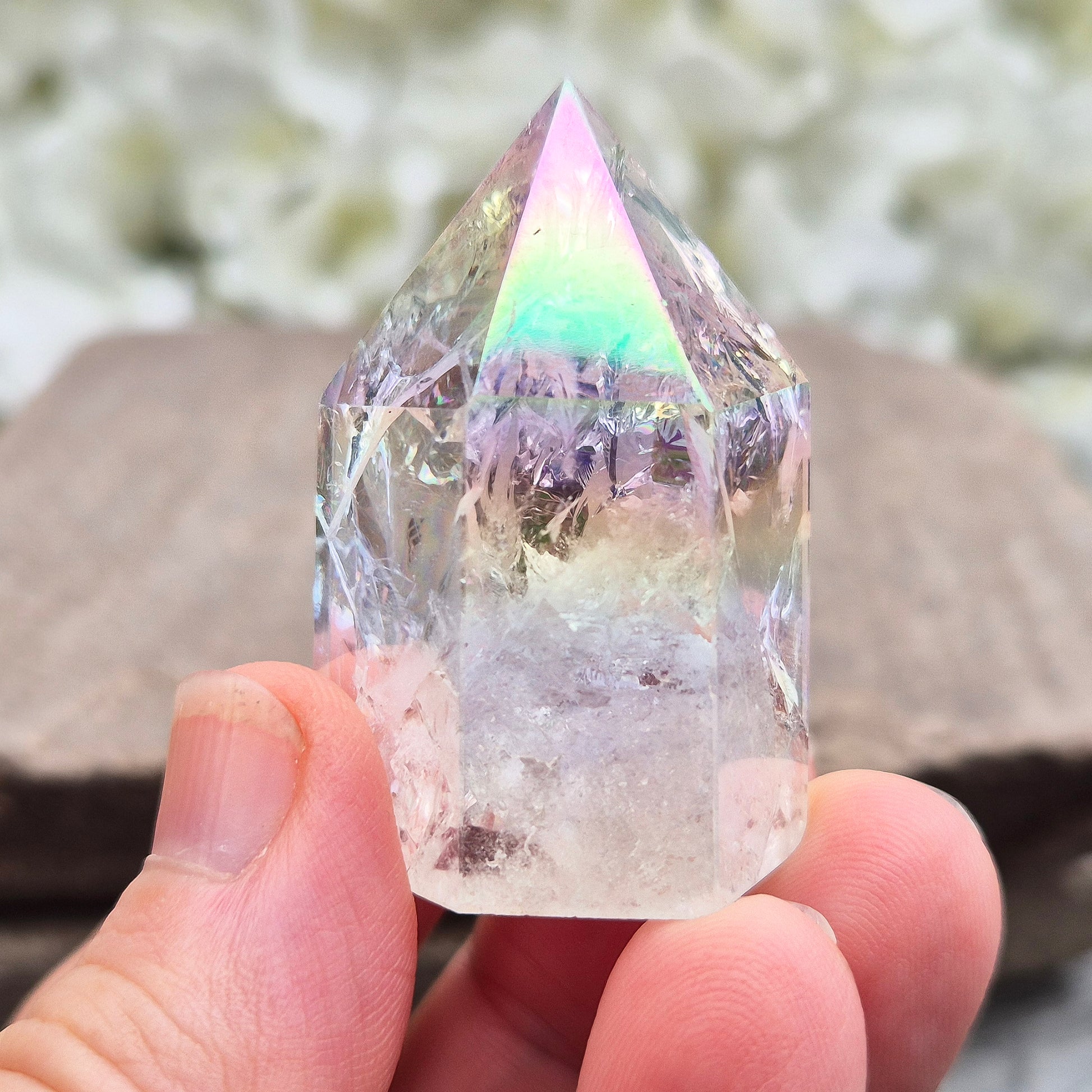 Aura Fire & Ice Quartz point with radiant rainbow flashes. Uplifting, self-cleansing crystal for meditation, intention and higher connection.