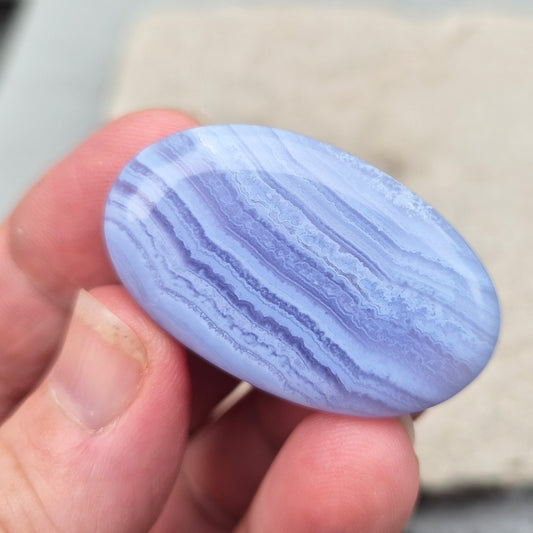 Polished Blue Lace Agate crystal palm stone. A calming crystal, ideal for relaxation, clear communication and gentle healing.