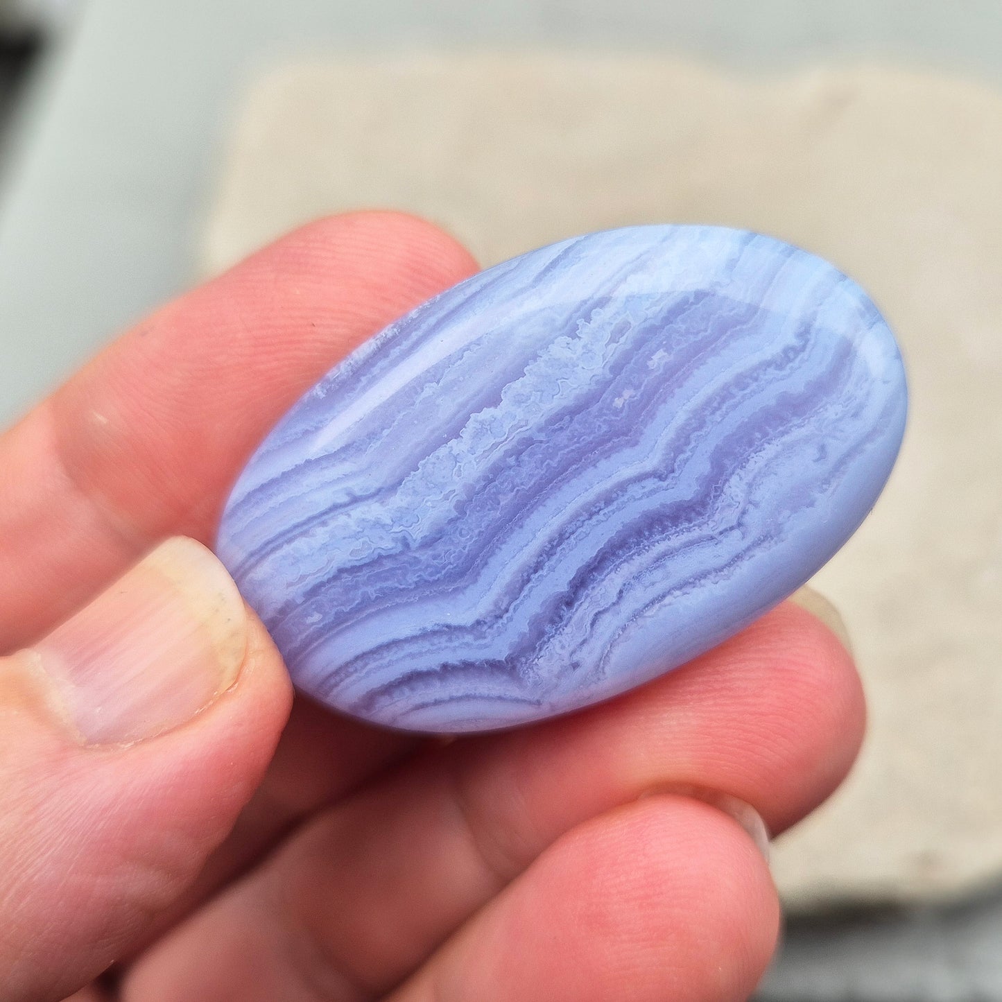 Polished Blue Lace Agate crystal palm stone. A calming crystal, ideal for relaxation, clear communication and gentle healing.