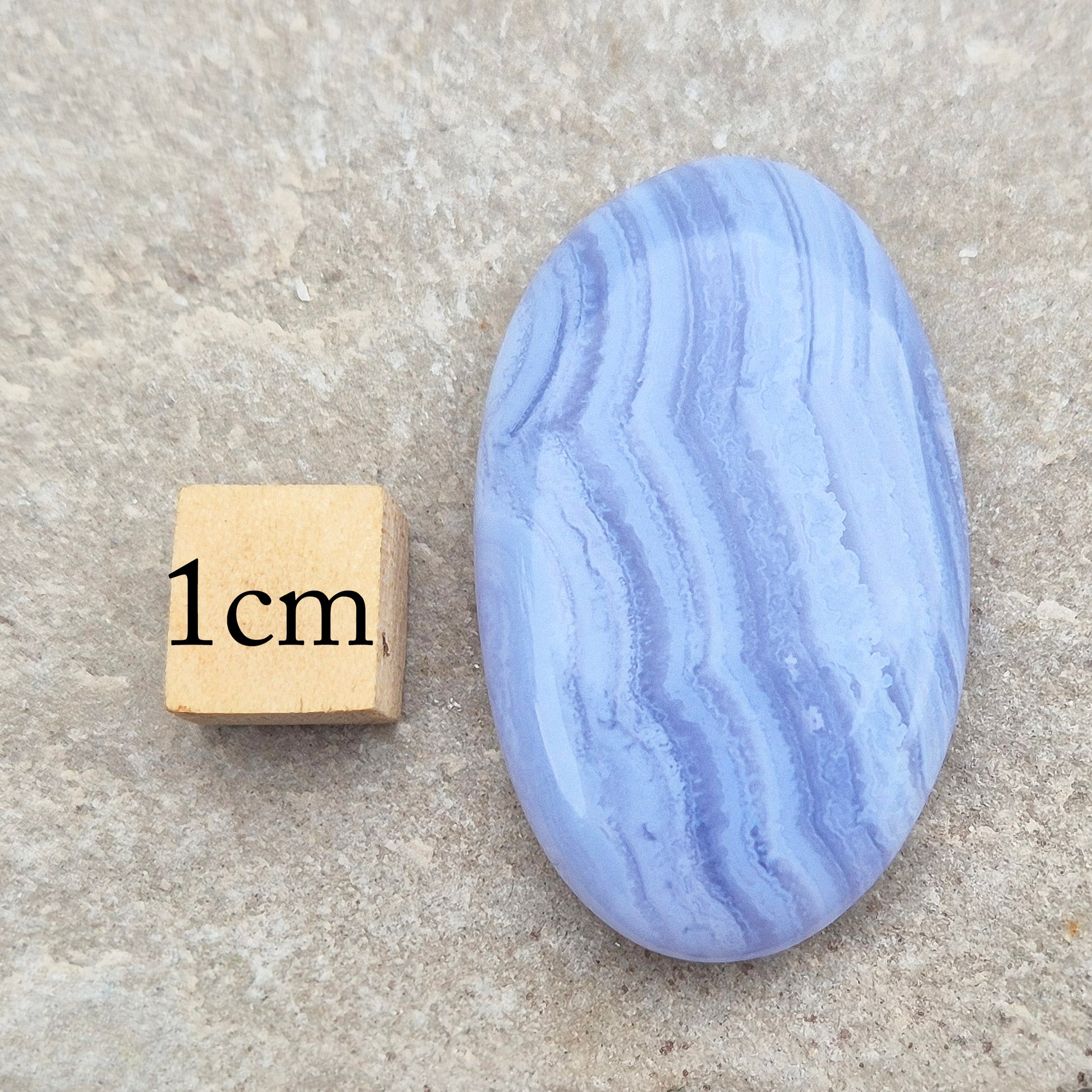 Polished Blue Lace Agate crystal palm stone. A calming crystal, ideal for relaxation, clear communication and gentle healing.