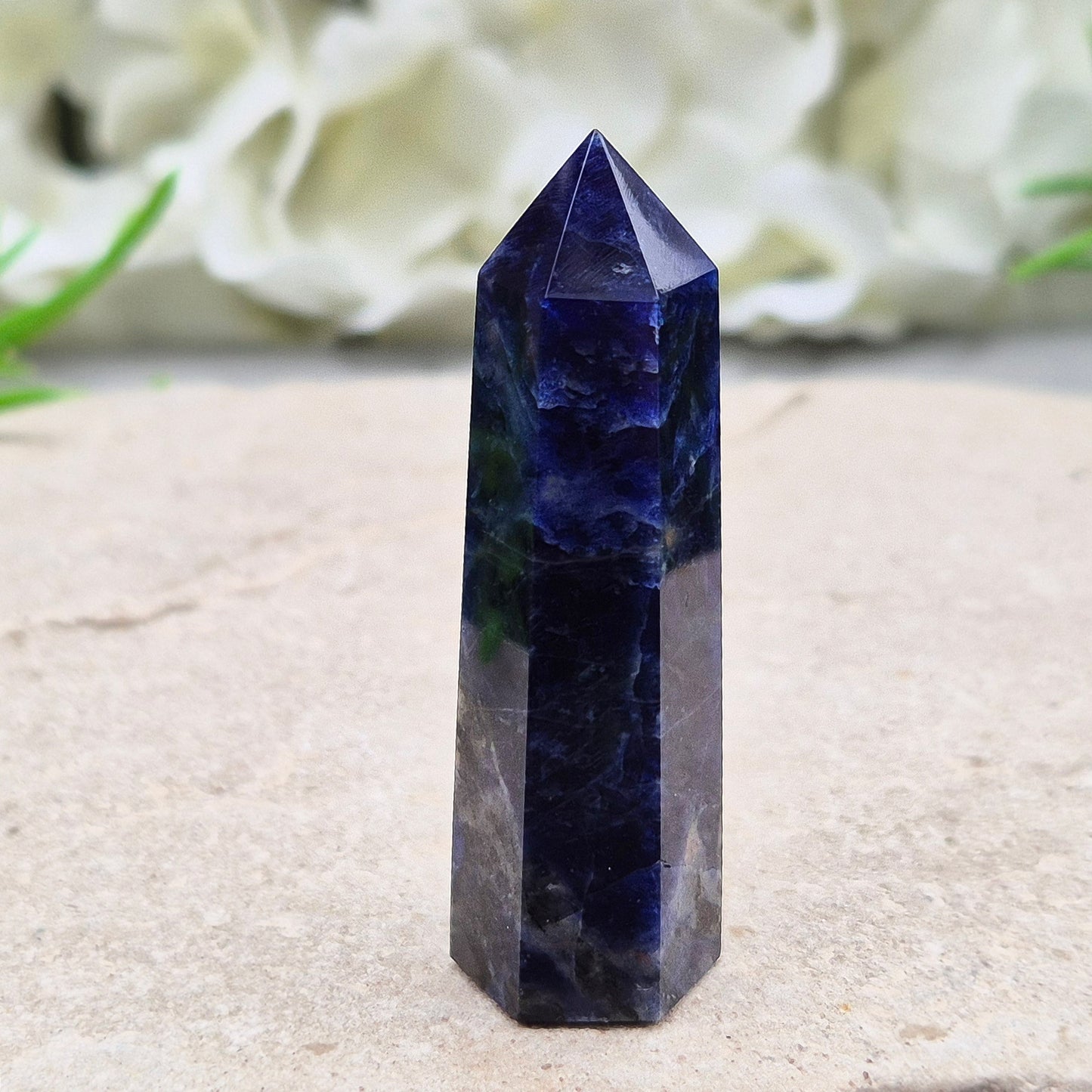 Beautiful Sodalite point that promotes insight, confidence, and inner peace. A grounding crystal for clear communication and self-expression.