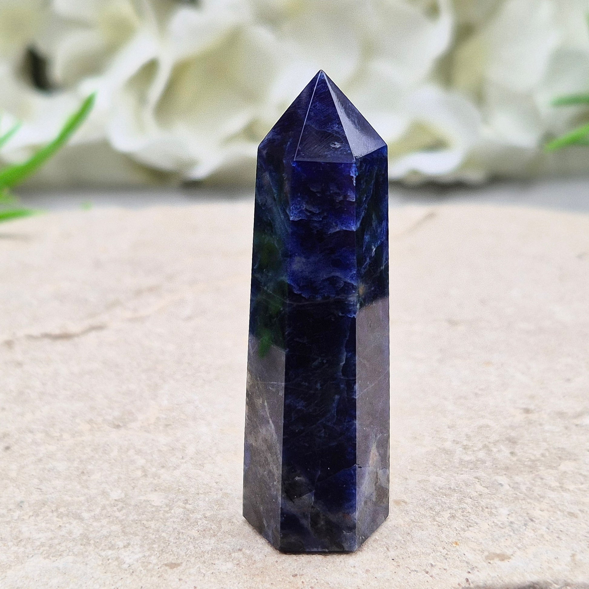 Beautiful Sodalite point that promotes insight, confidence, and inner peace. A grounding crystal for clear communication and self-expression.