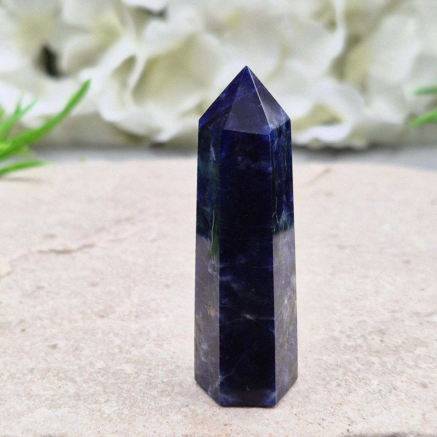 Beautiful Sodalite point that promotes insight, confidence, and inner peace. A grounding crystal for clear communication and self-expression.