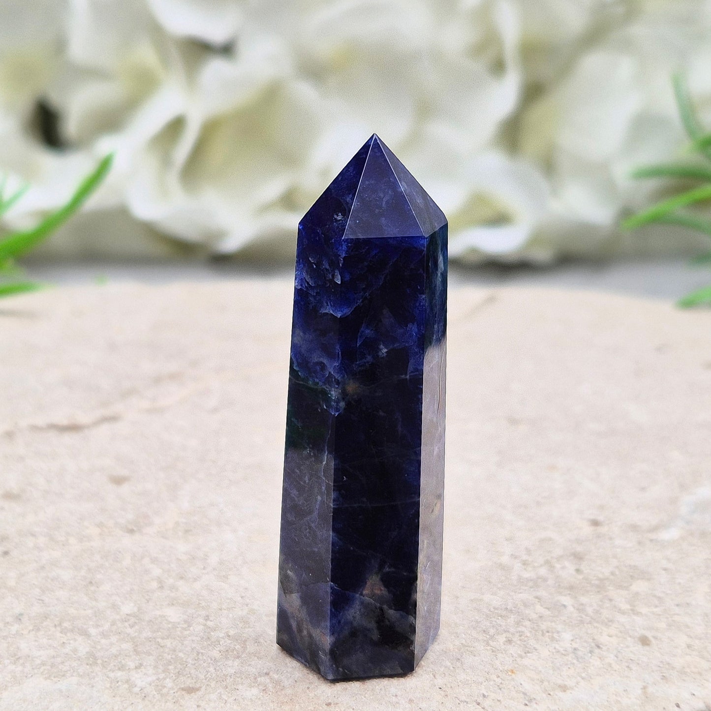 Beautiful Sodalite point that promotes insight, confidence, and inner peace. A grounding crystal for clear communication and self-expression.