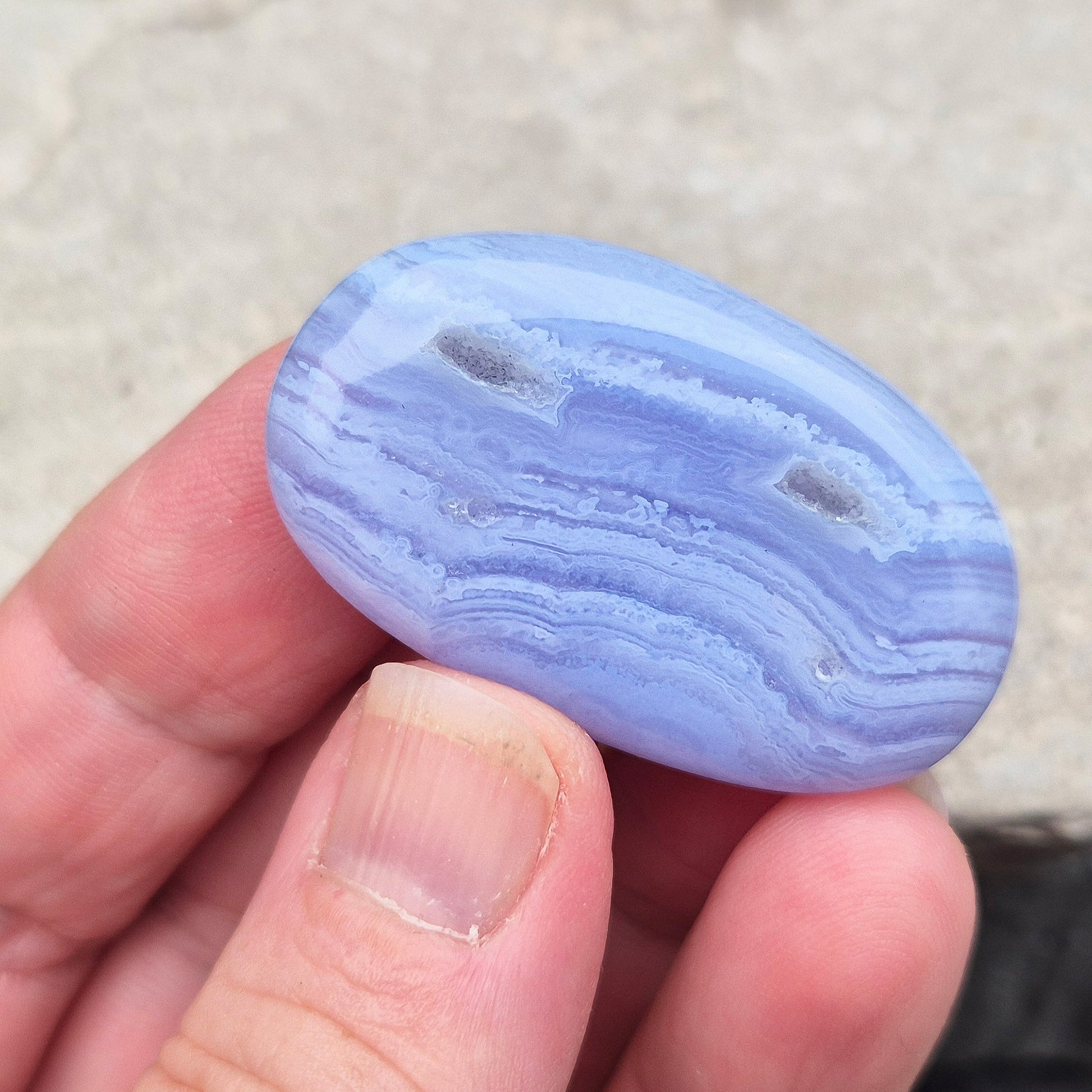 Polished Blue Lace Agate crystal palm stone with wonderful banding. A calming crystal, ideal for relaxation, clear communication and gentle healing. 