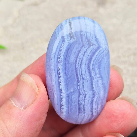 Polished Blue Lace Agate crystal palm stone with wonderful banding. A calming crystal, ideal for relaxation, clear communication and gentle healing. 