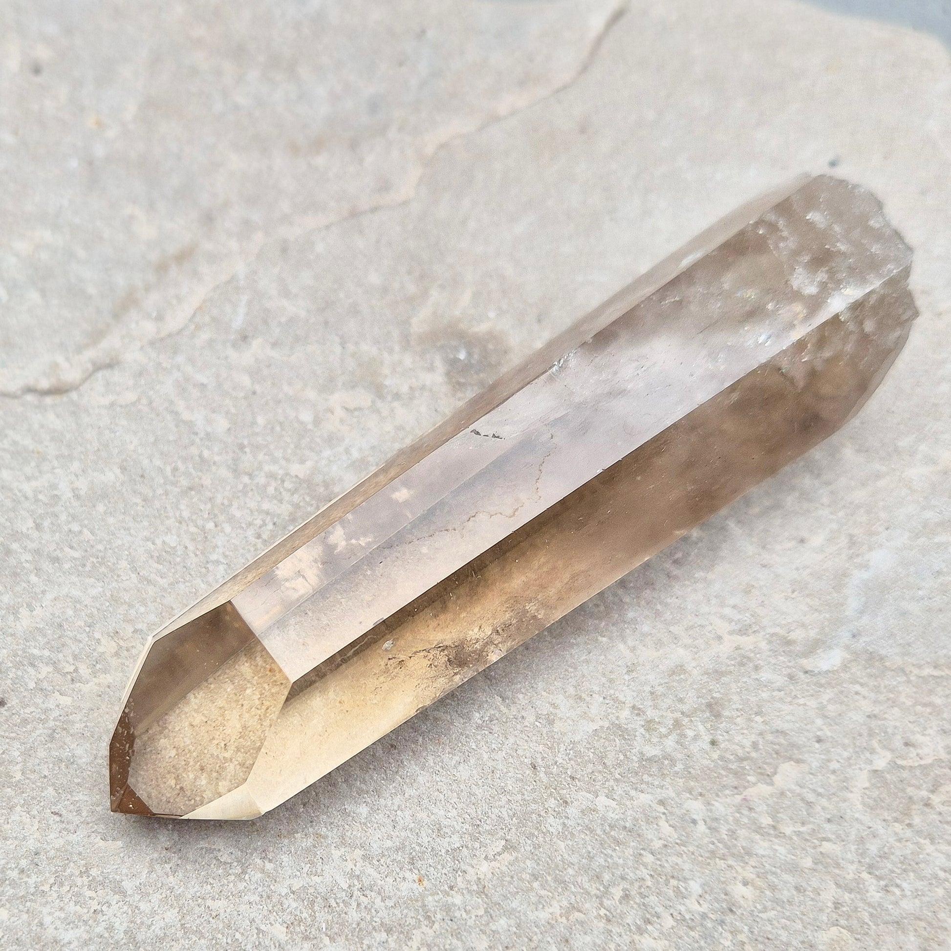 Natural Smoky Quartz crystal point — a powerful grounding stone for balance, protection, and letting go of unwanted energy.