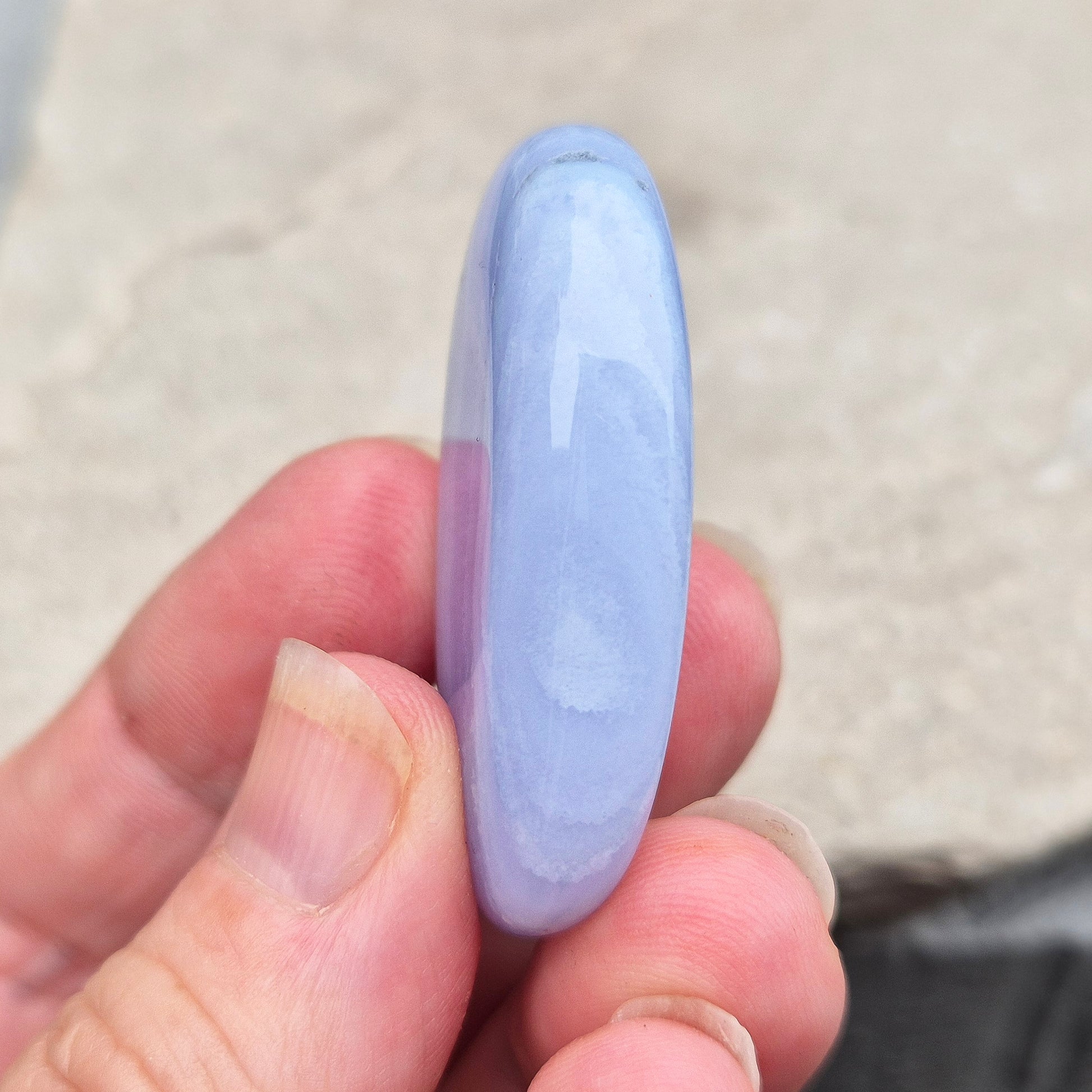 Smooth Blue Lace Agate palm stone for calm, soothing energy and stress relief. Ideal for meditation, healing practices, or carrying with you.