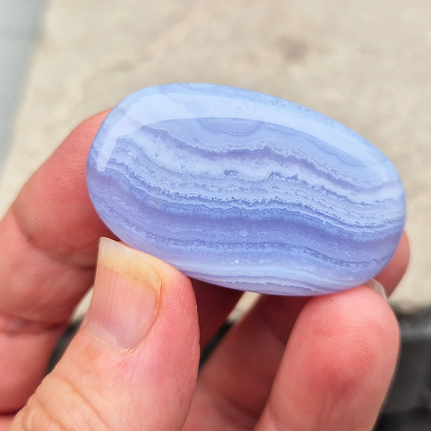 Smooth Blue Lace Agate palm stone for calm, soothing energy and stress relief. Ideal for meditation, healing practices, or carrying with you.