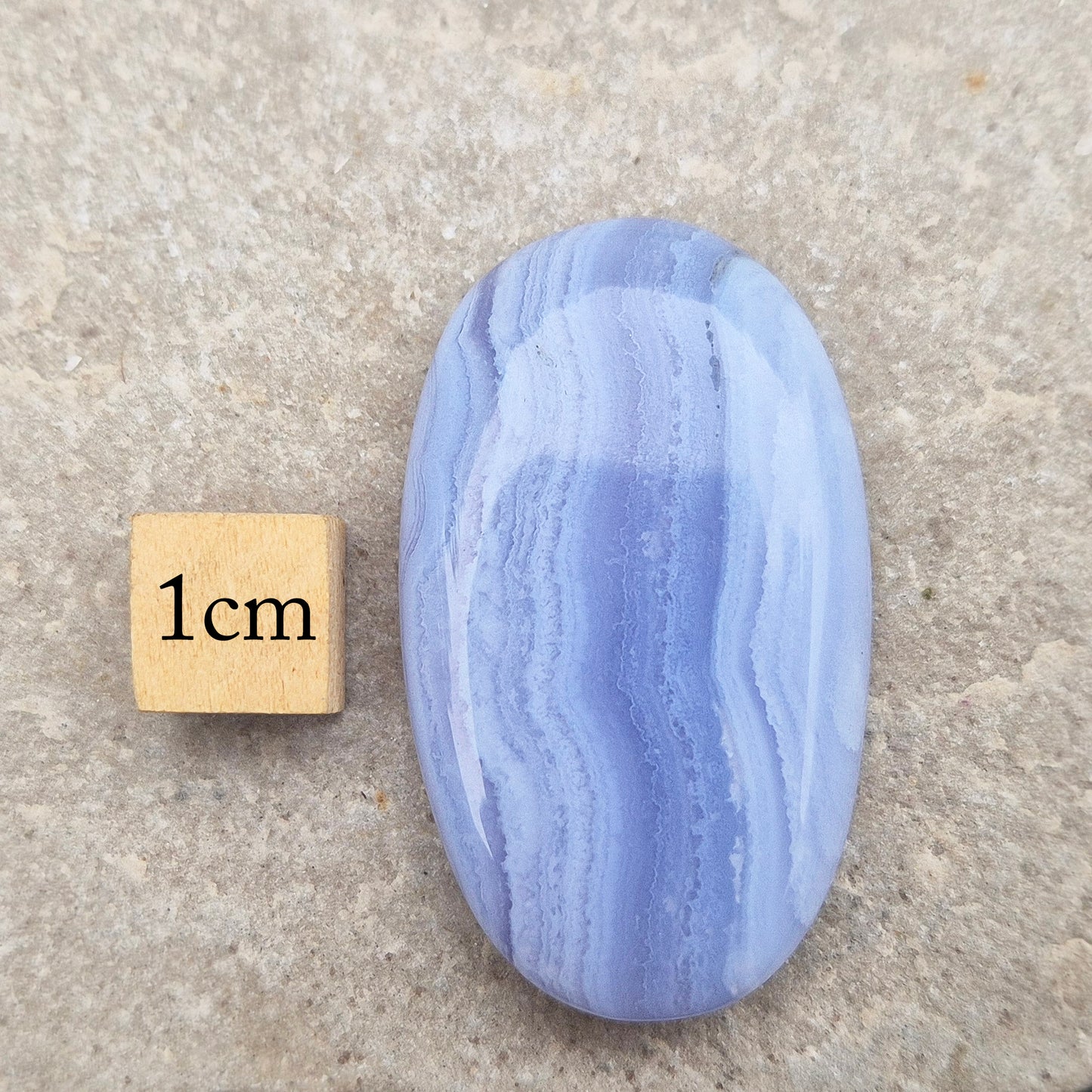 Smooth Blue Lace Agate palm stone for calm, soothing energy and stress relief. Ideal for meditation, healing practices, or carrying with you.