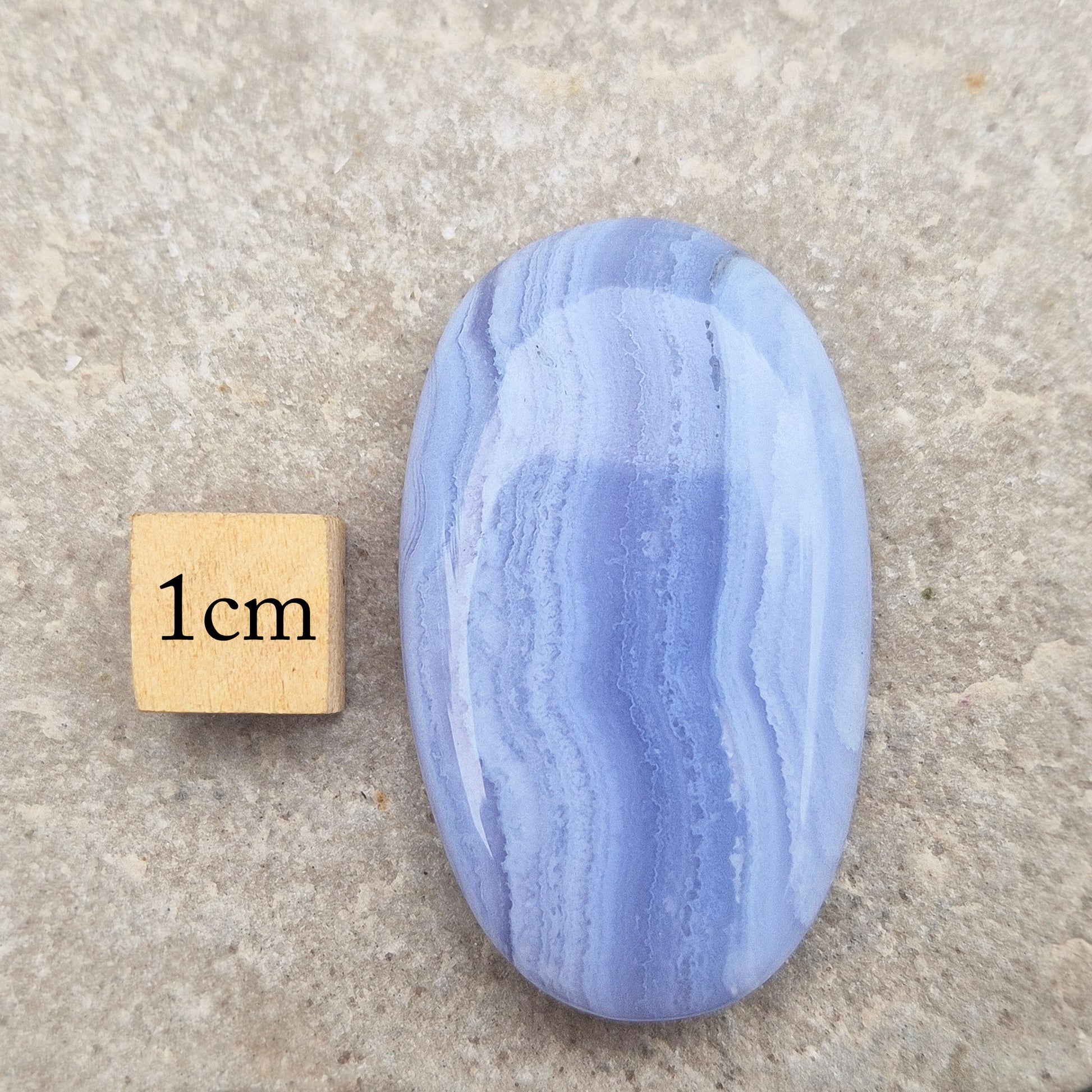 Smooth Blue Lace Agate palm stone for calm, soothing energy and stress relief. Ideal for meditation, healing practices, or carrying with you.
