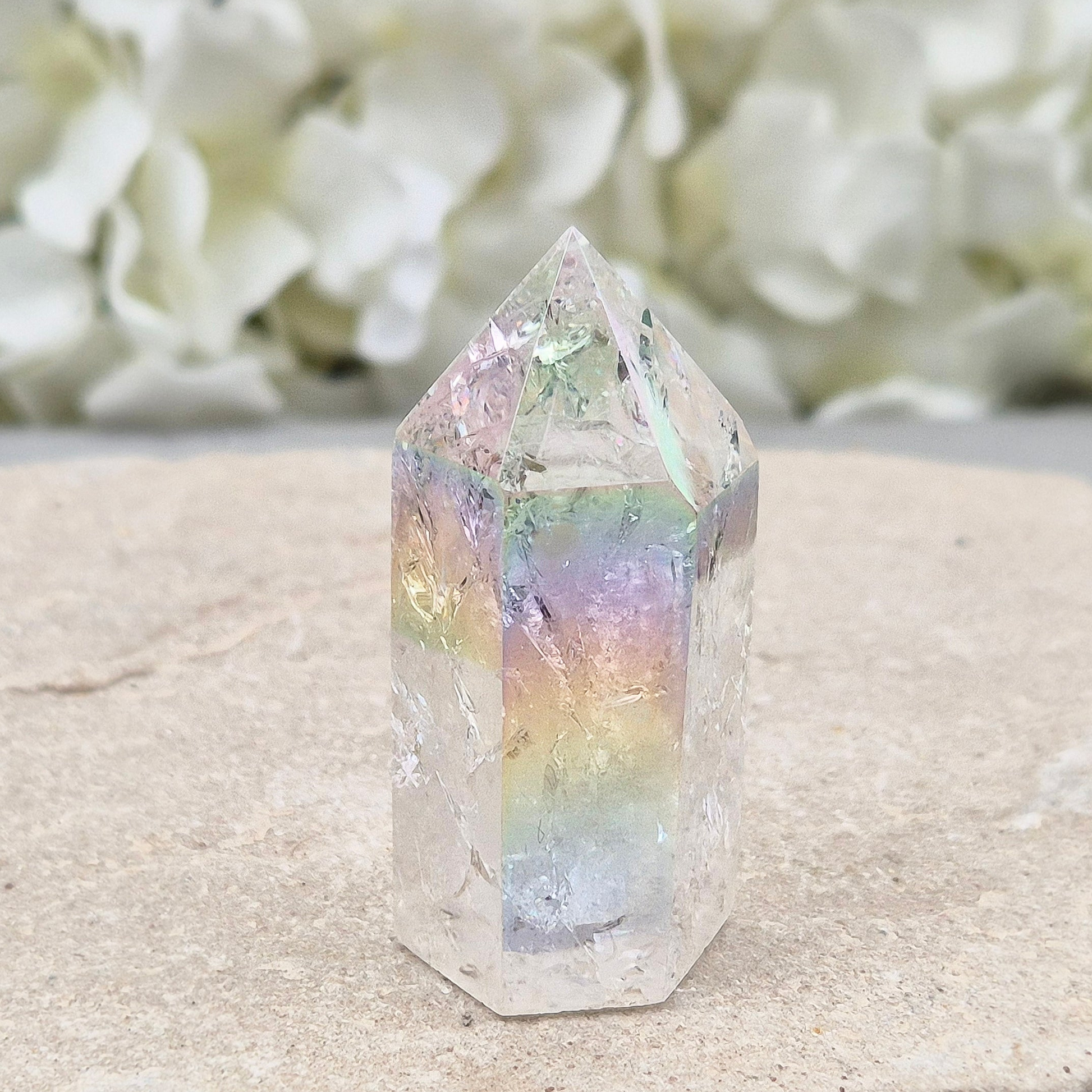 Aura Fire and Ice Quartz standing point with rainbow flashes and iridescent finish. A bright crystal for uplifting spaces, clearer thinking, and spiritual work.