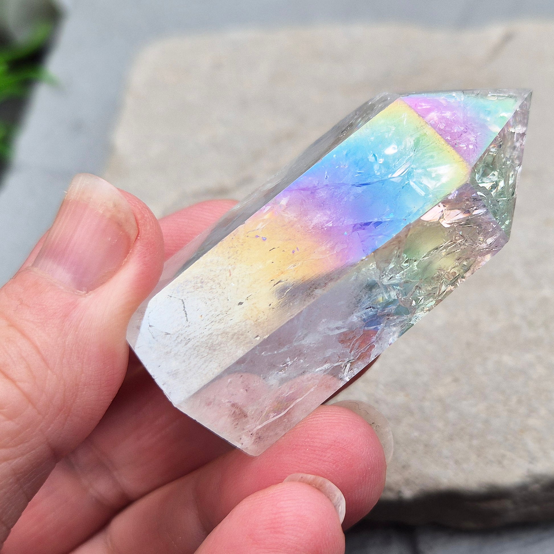 Aura Fire and Ice Quartz standing point with rainbow flashes and iridescent finish. A bright crystal for uplifting spaces, clearer thinking, and spiritual work.