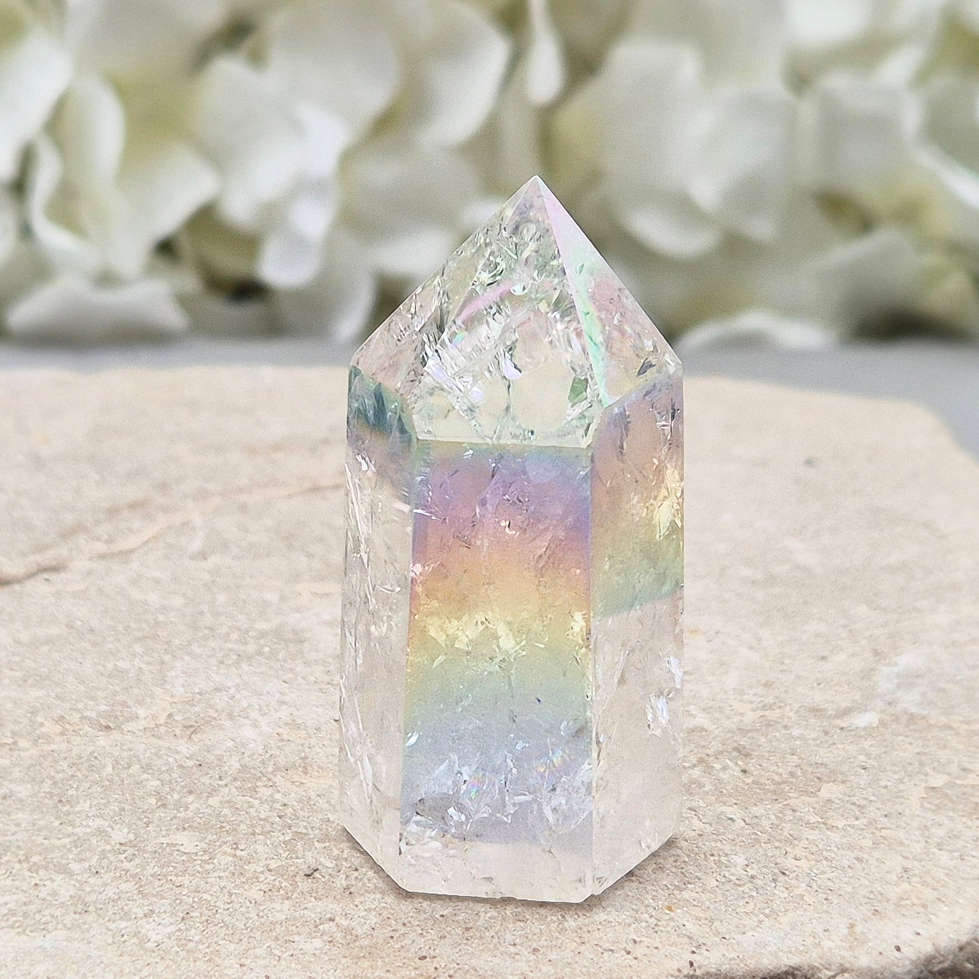 Aura Fire and Ice Quartz standing point with rainbow flashes and iridescent finish. A bright crystal for uplifting spaces, clearer thinking, and spiritual work.