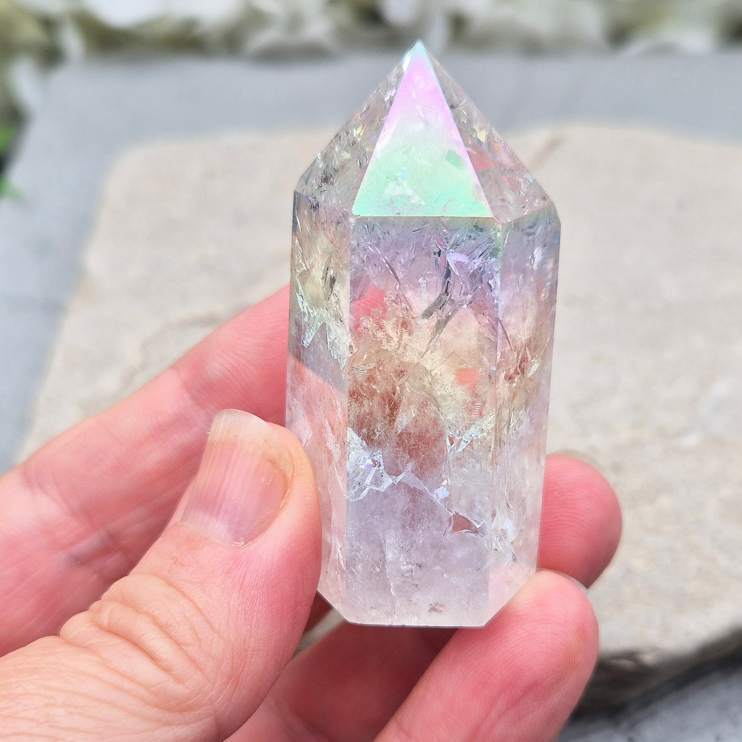 Aura Fire and Ice Quartz standing point with rainbow flashes and iridescent finish. A bright crystal for uplifting spaces, clearer thinking, and spiritual work.