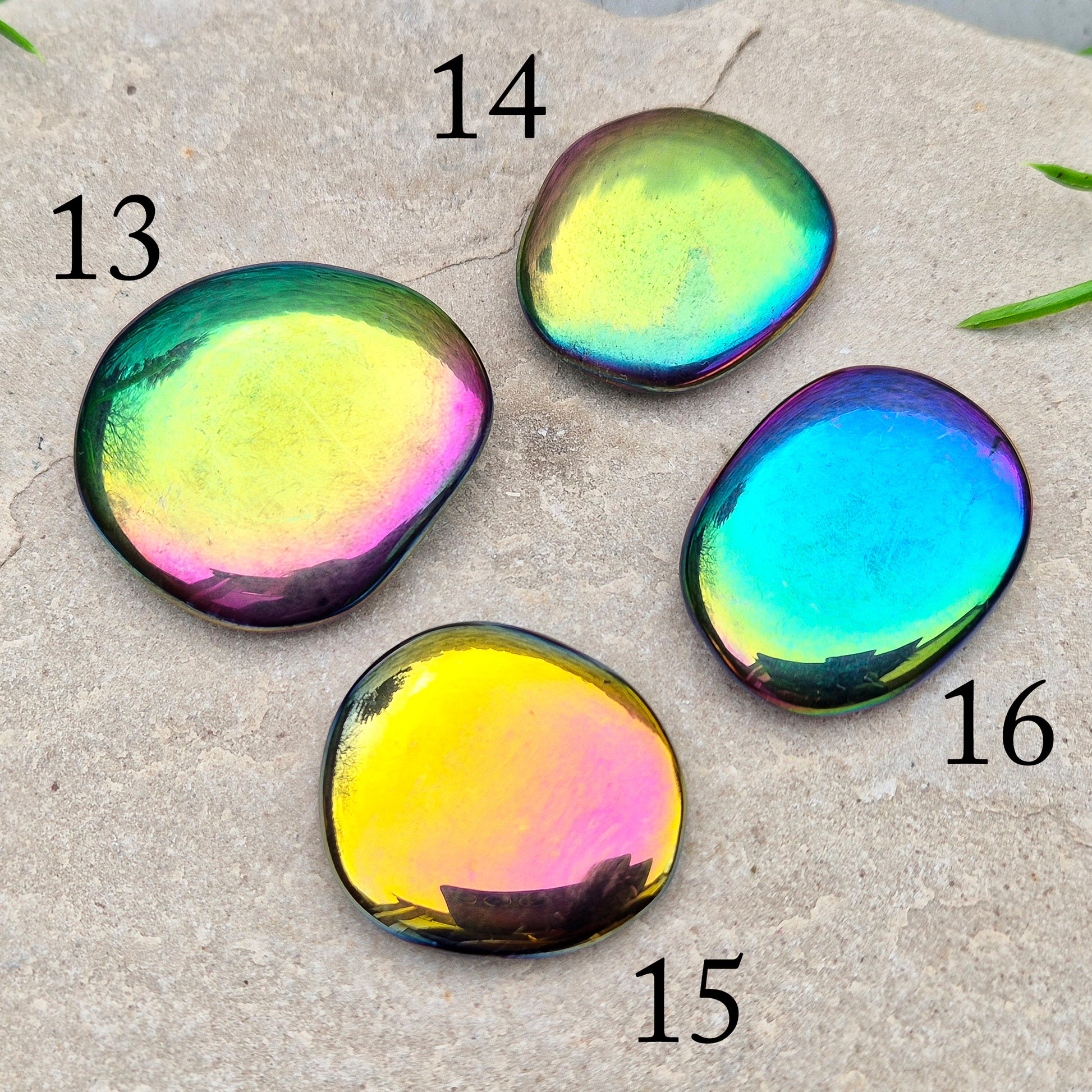 Discover our Titanium Aura Obsidian Palm Stones. This crystal calms anxiety and balances your energy and chakras. It protects against negative energy.