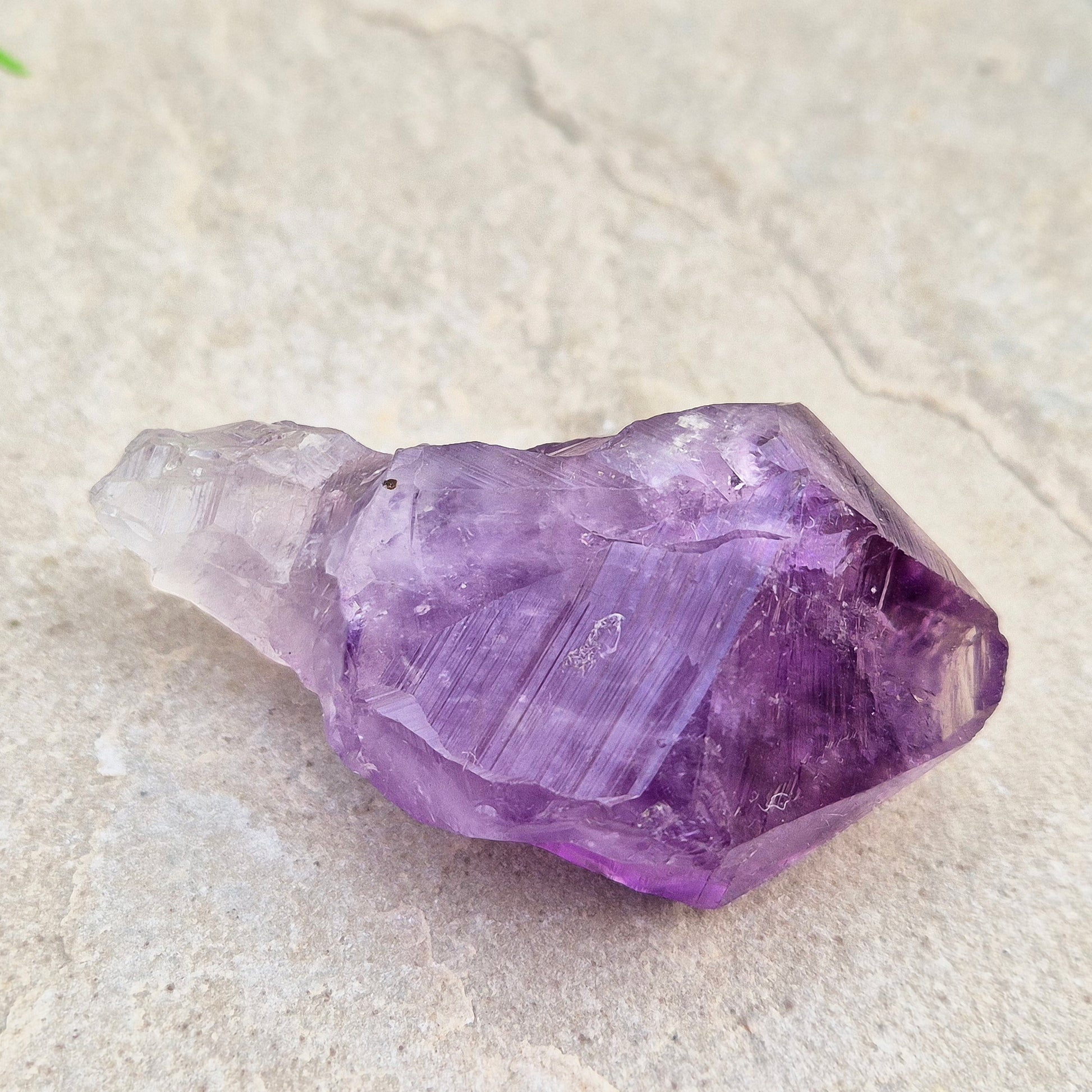 A pair of Amethyust Points with a natural Amethyst "root" formation from Brazil. The points have a polshhed point and natural body — a form sometimes called Amethyst Teeth because of its distinctive shape.