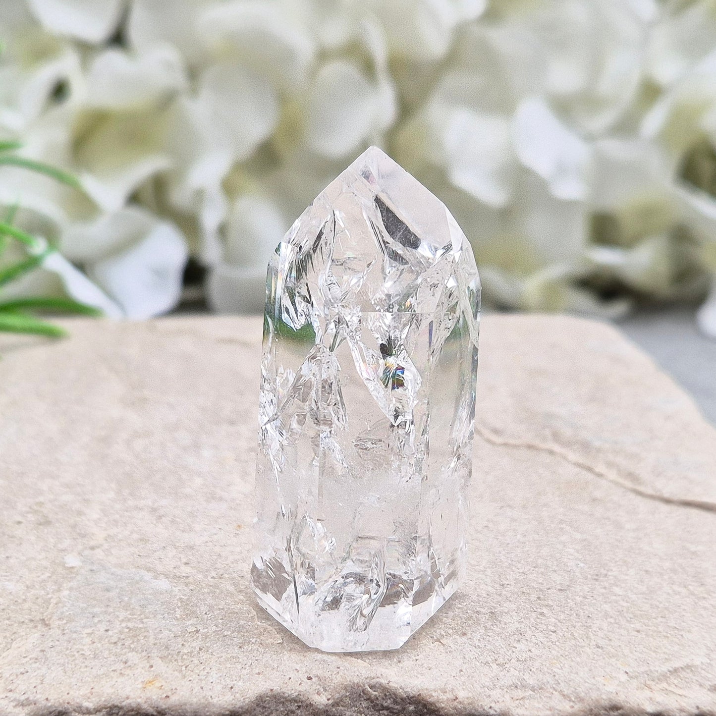 Polished Fire & Ice Quartz point with vibrant internal fractures. Ideal for energy work, meditation and crystal healing. A striking addition to any collection.