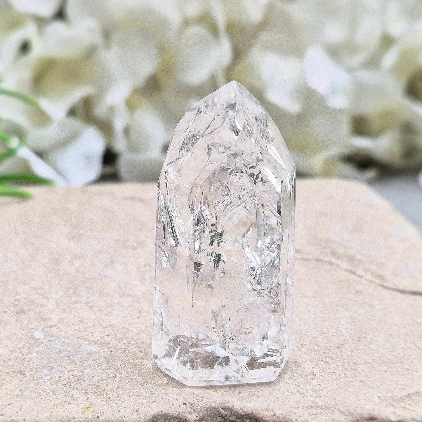 Polished Fire & Ice Quartz point with vibrant internal fractures. Ideal for energy work, meditation and crystal healing. A striking addition to any collection.