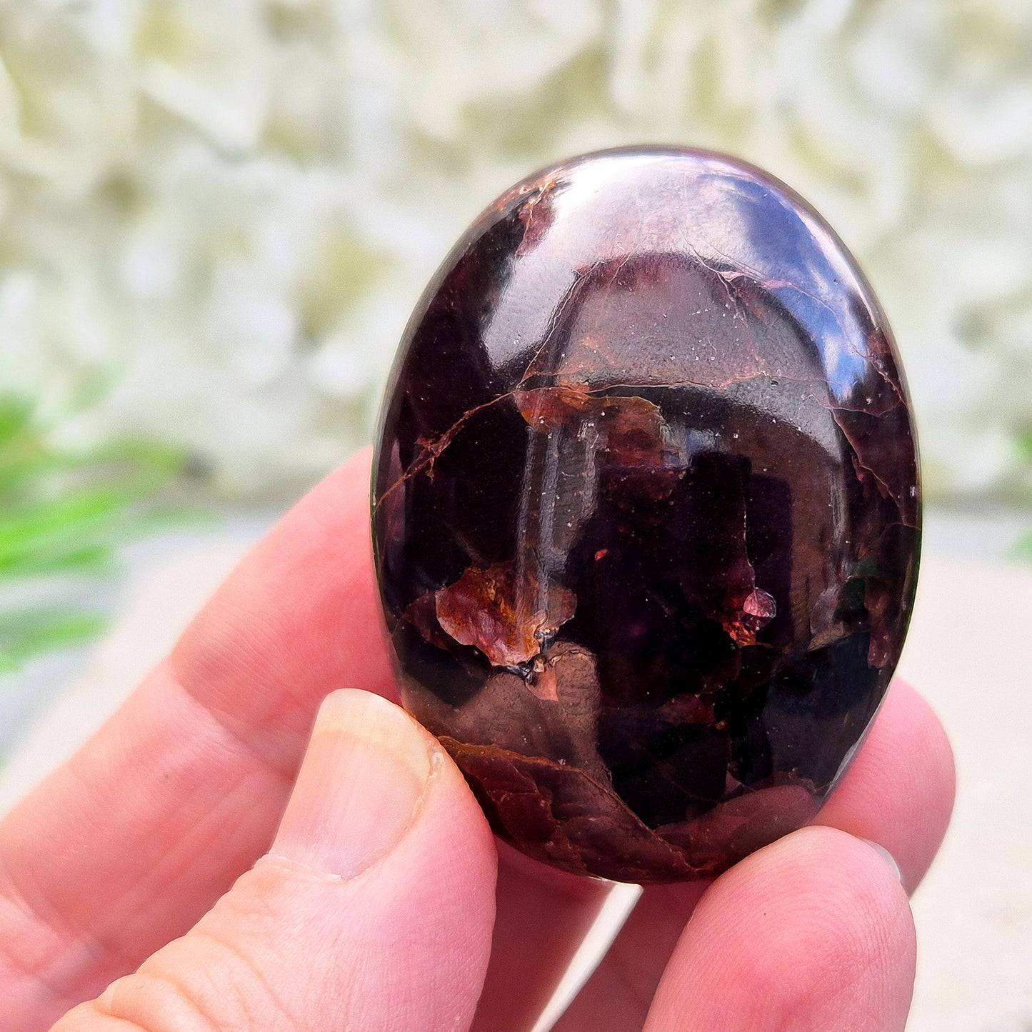 Rare Star Garnet palm stone with striking asterism. Perfect for collectors and crystal lovers seeking unique, grounding energy.