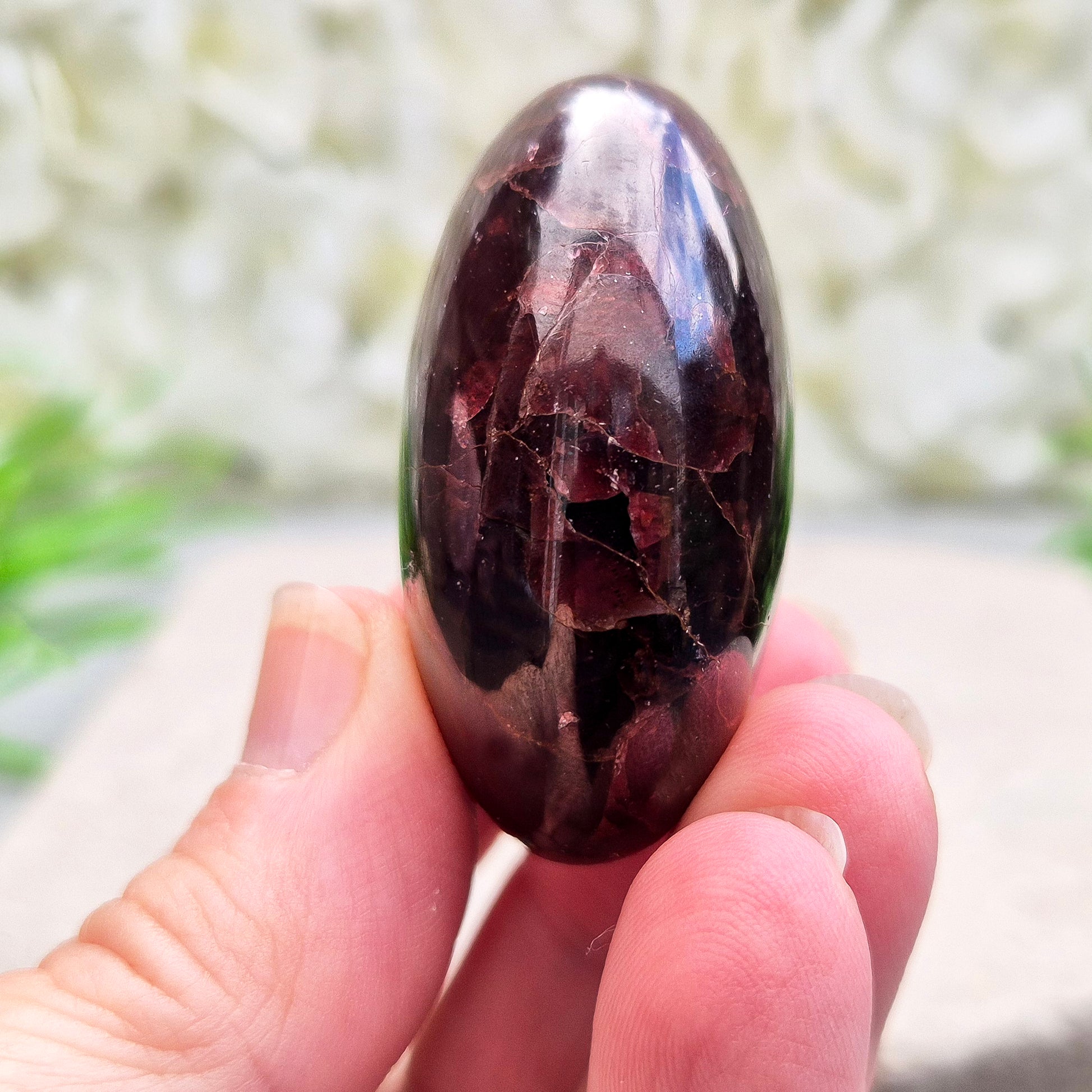 Rare Star Garnet palm stone with striking asterism. Perfect for collectors and crystal lovers seeking unique, grounding energy.