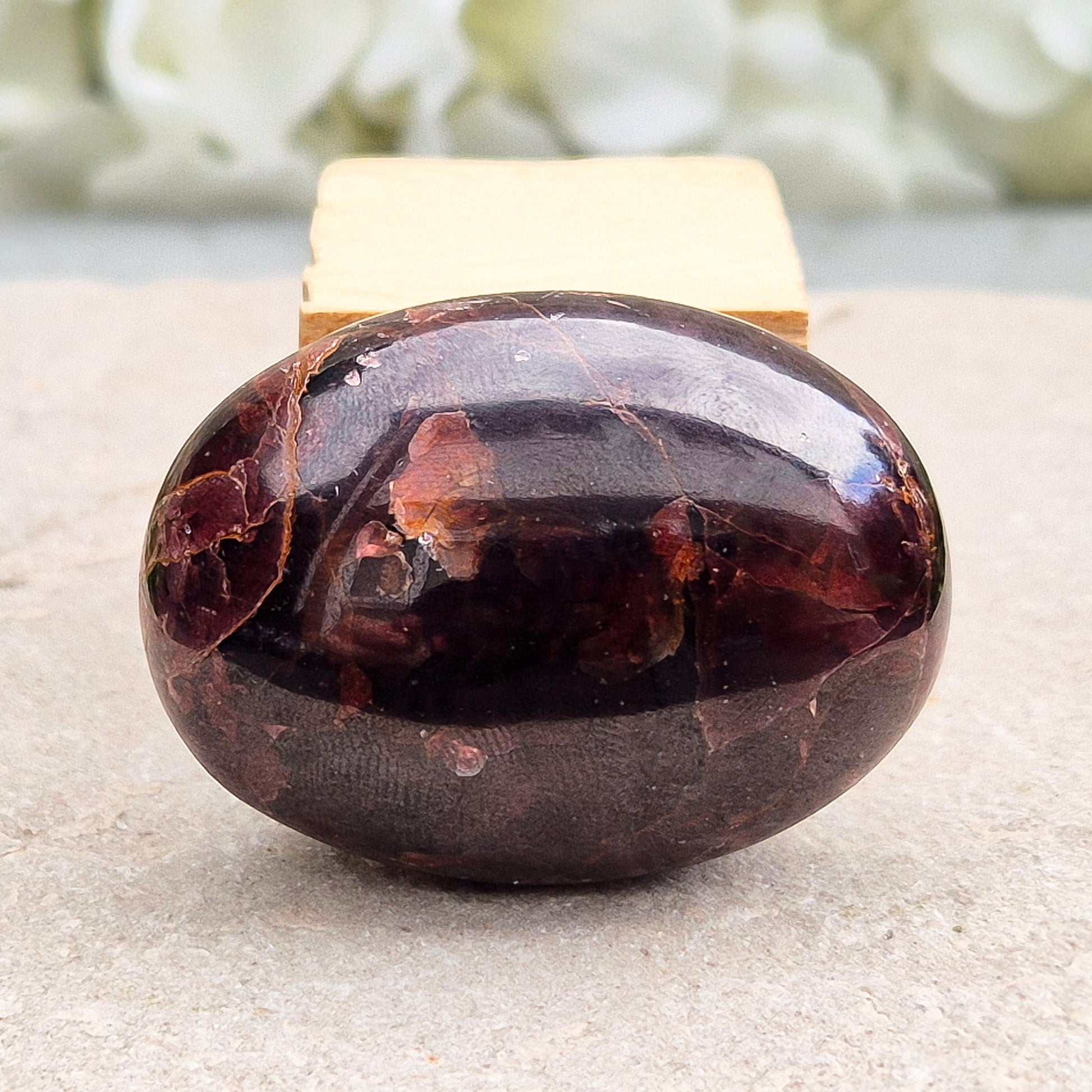 Rare Star Garnet palm stone with striking asterism. Perfect for collectors and crystal lovers seeking unique, grounding energy.