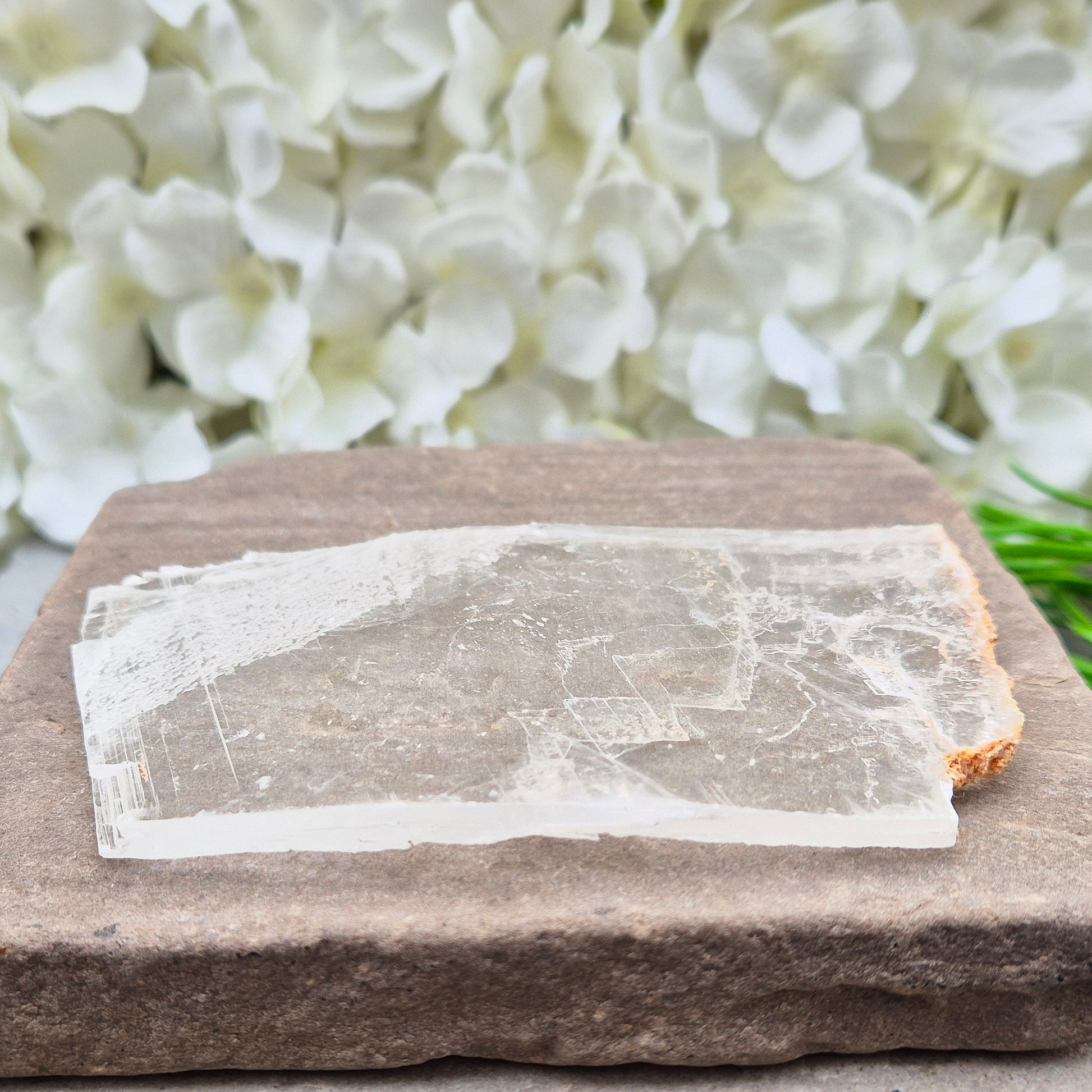 A natural gypsum window plate for cleansing and charging crystals. Clears stagnant energy, supports intuition, and keeps your space energetically fresh.
