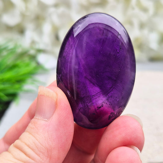 Amethyst Palm Stone with deep purple tones. A soothing crystal for balance, peaceful energy, and gentle spiritual connection.