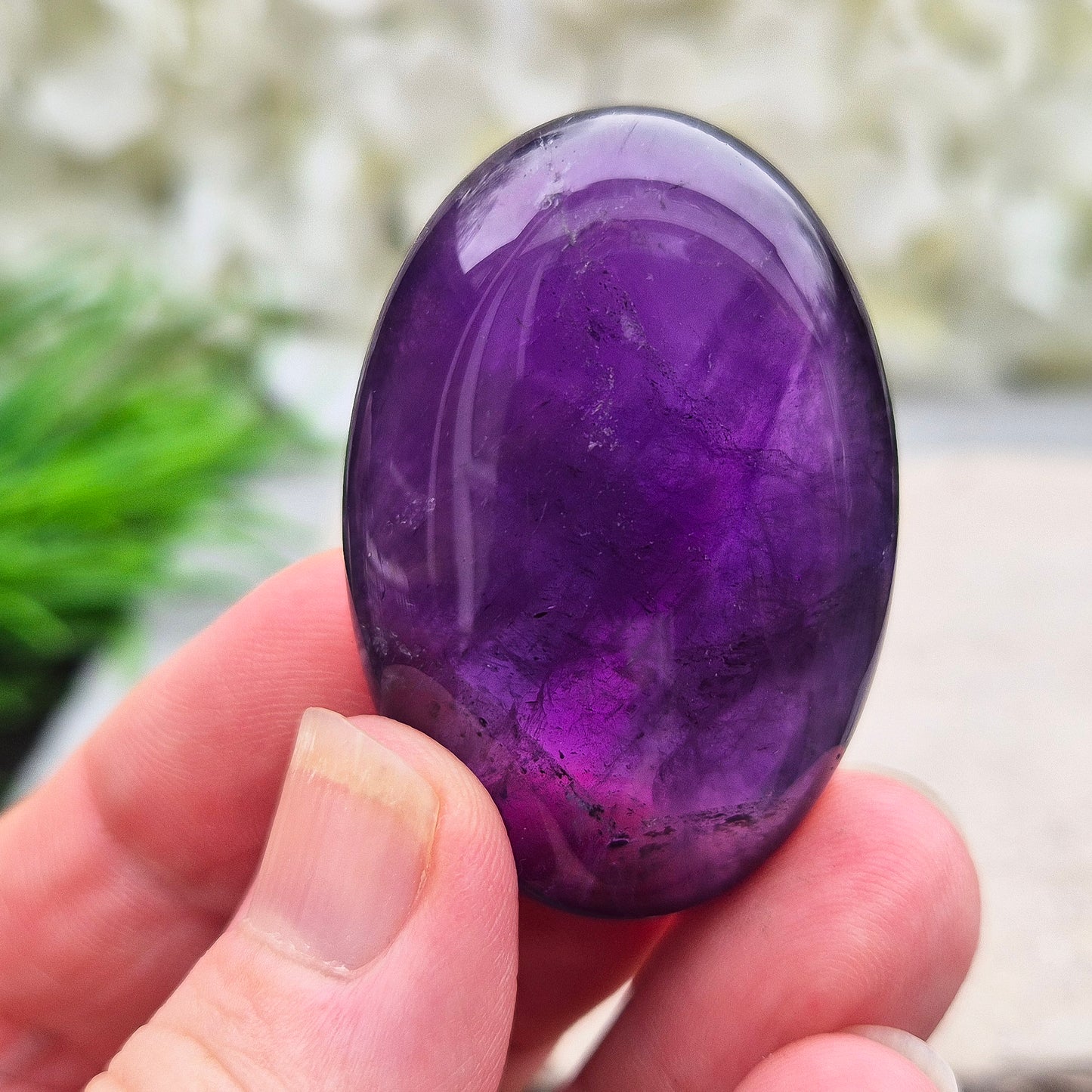 Amethyst Palm Stone with deep purple tones. A soothing crystal for balance, peaceful energy, and gentle spiritual connection.