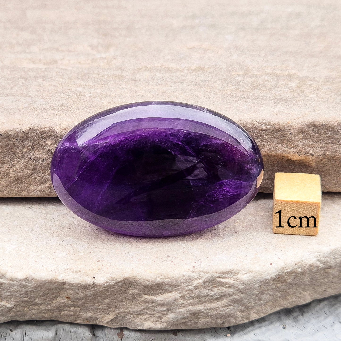 Amethyst Palm Stone with deep purple tones. A soothing crystal for balance, peaceful energy, and gentle spiritual connection.