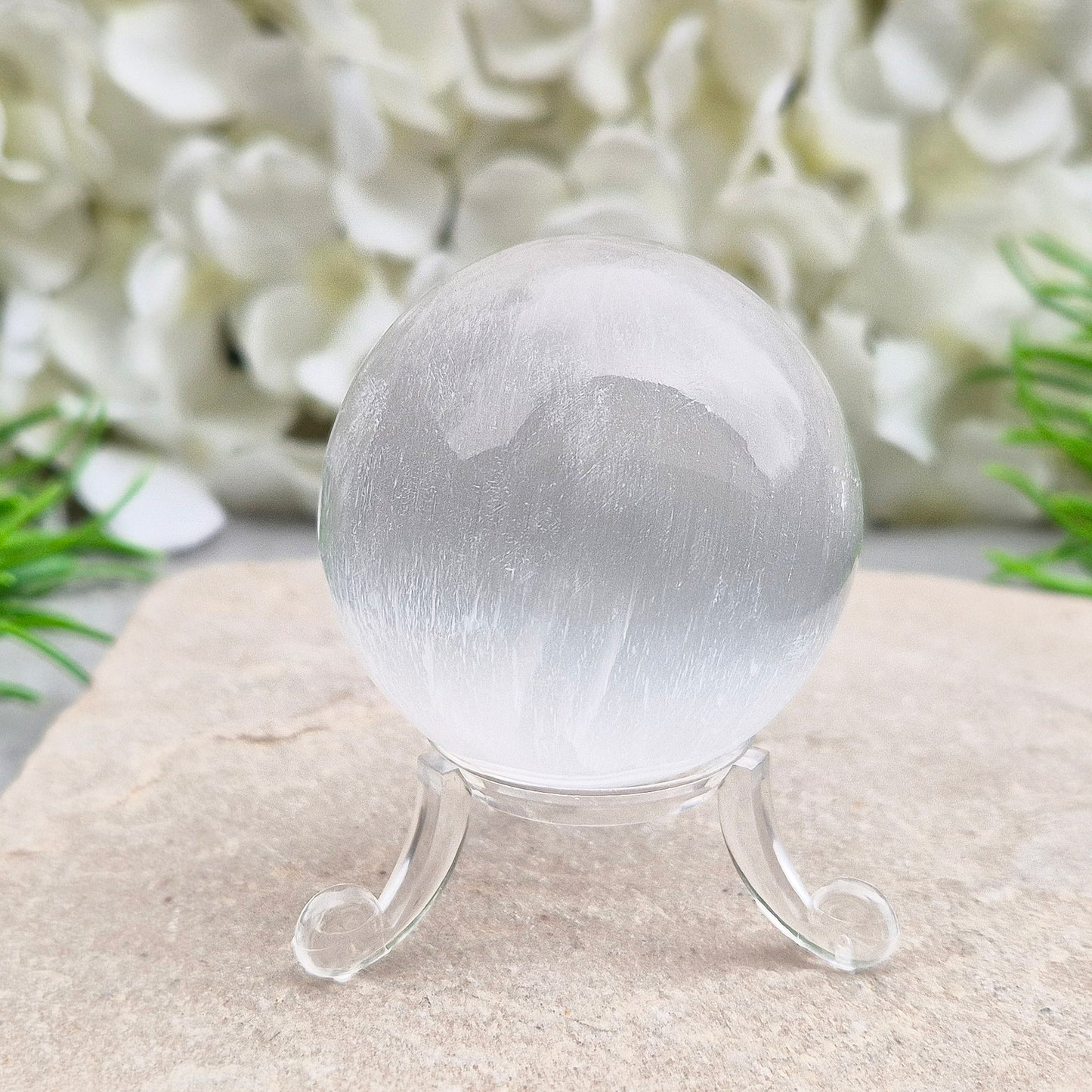 Selenite crystal ball with a soft, luminous glow. Ideal for cleansing energy, creating a peaceful atmosphere, and displaying as a calming centrepiece.