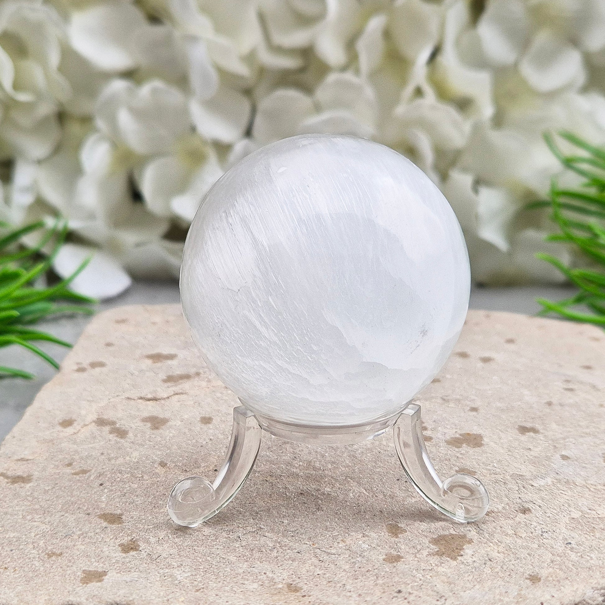 Selenite crystal ball with a soft, luminous glow. Ideal for cleansing energy, creating a peaceful atmosphere, and displaying as a calming centrepiece.
