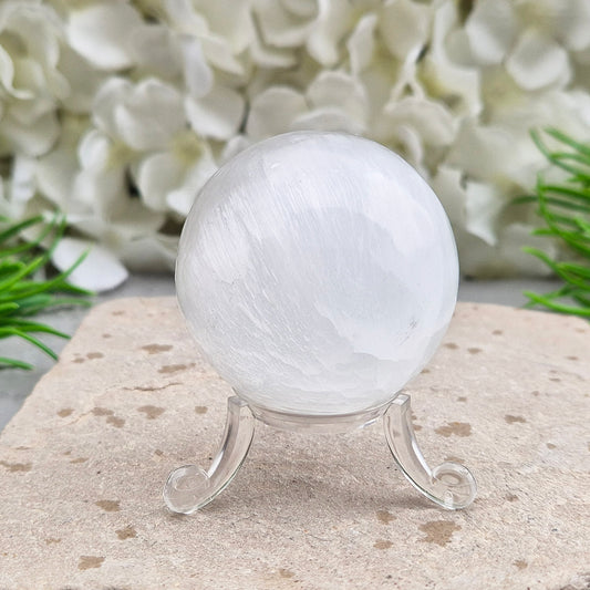 Selenite crystal ball with a soft, luminous glow. Ideal for cleansing energy, creating a peaceful atmosphere, and displaying as a calming centrepiece.