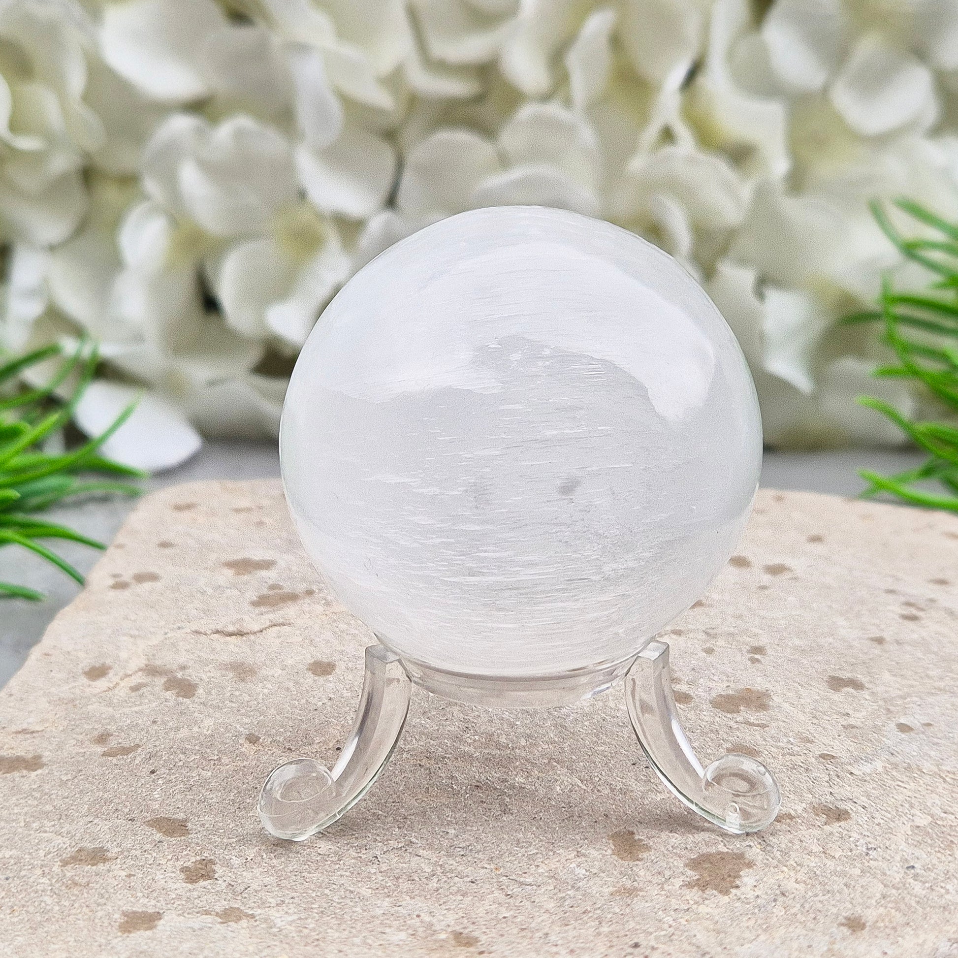 Selenite crystal ball with a soft, luminous glow. Ideal for cleansing energy, creating a peaceful atmosphere, and displaying as a calming centrepiece.