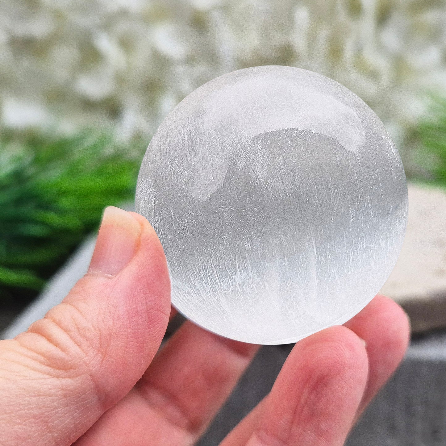 Selenite crystal ball with a soft, luminous glow. Ideal for cleansing energy, creating a peaceful atmosphere, and displaying as a calming centrepiece.