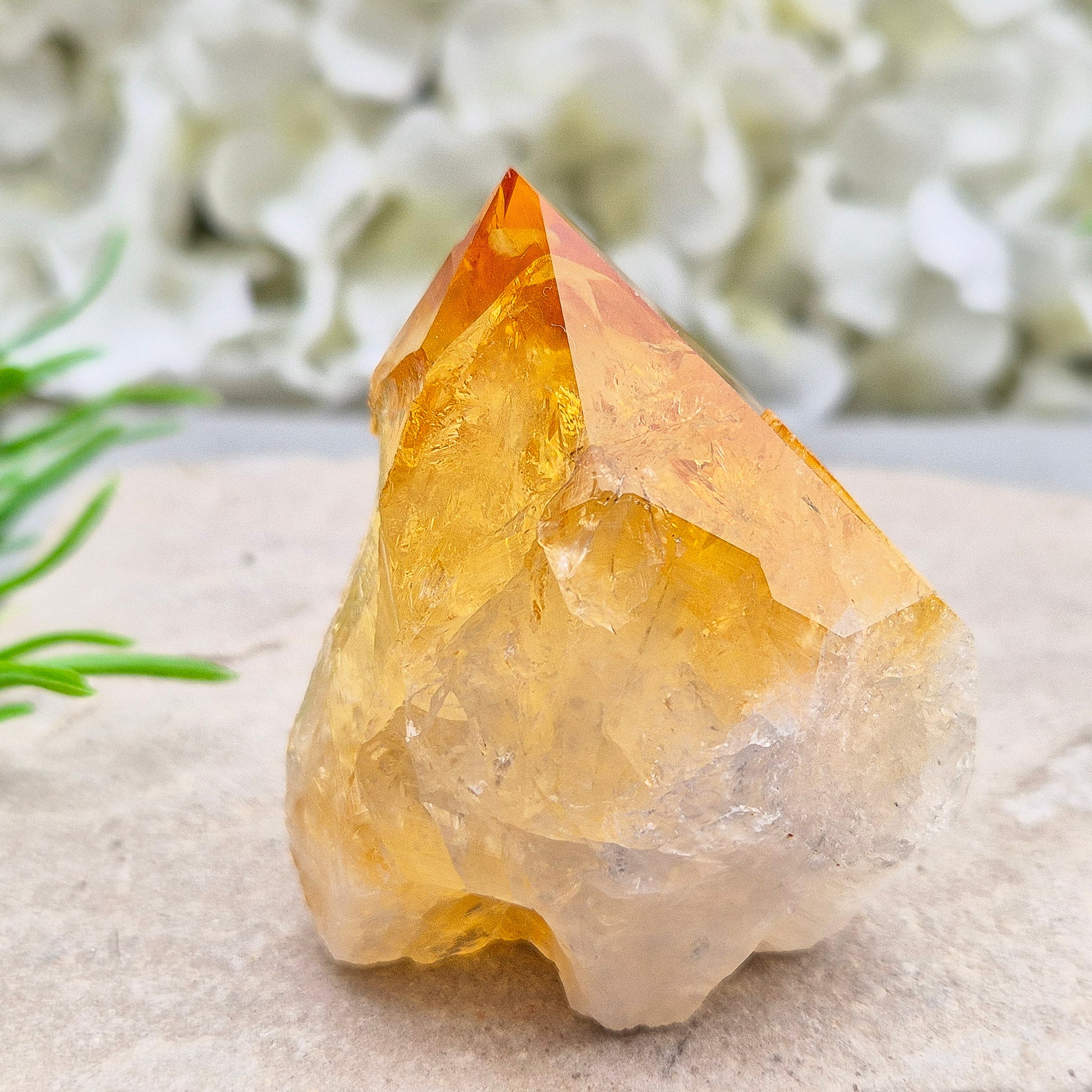 Citrine crystal standing point from Brazil with a polished tip and natural sides. Associated with confidence, motivation, positivity, and personal growth.