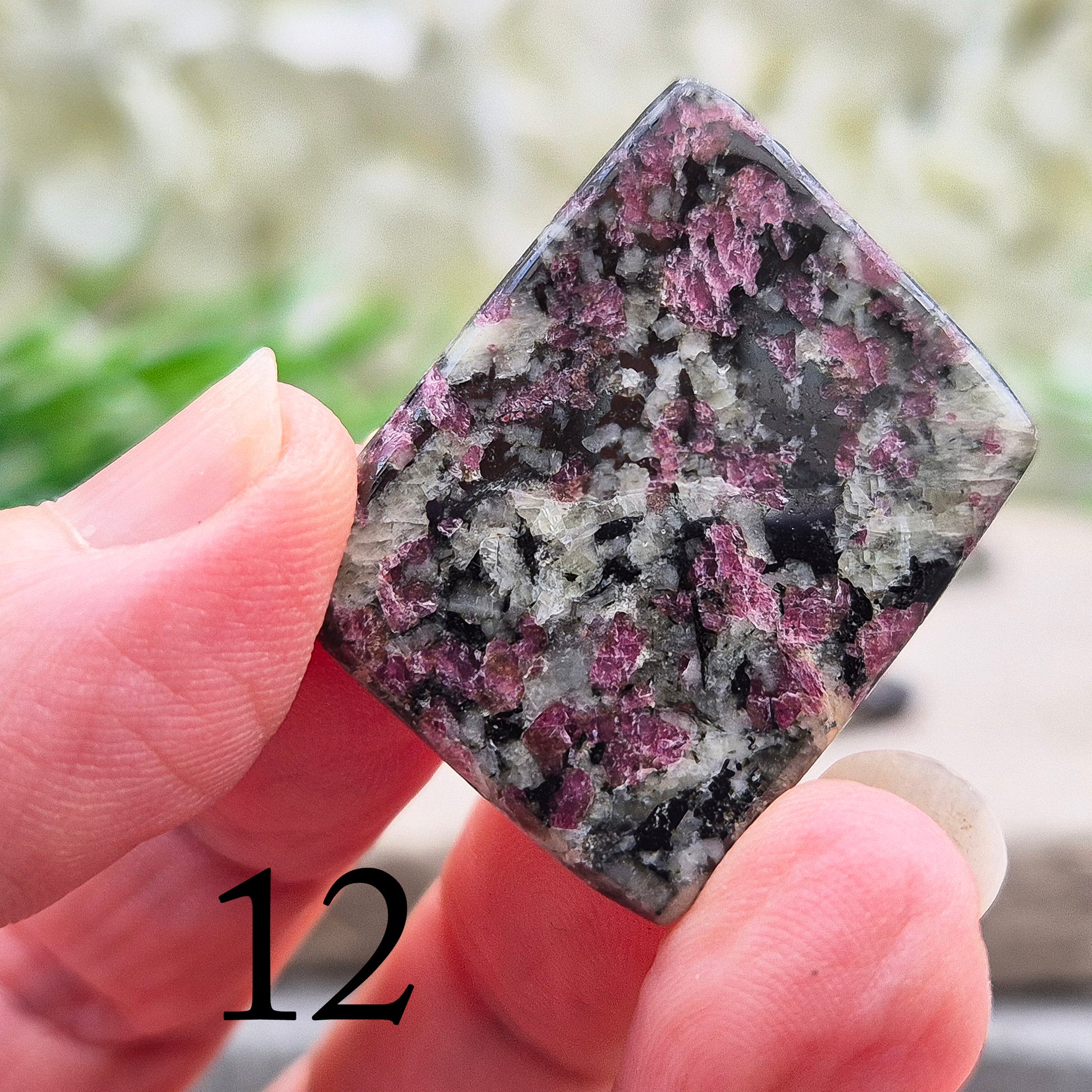 Polished Eudialyte flat stone from Greenland with rich red and pink tones. Associated with emotional steadiness, heart support, and grounded change.