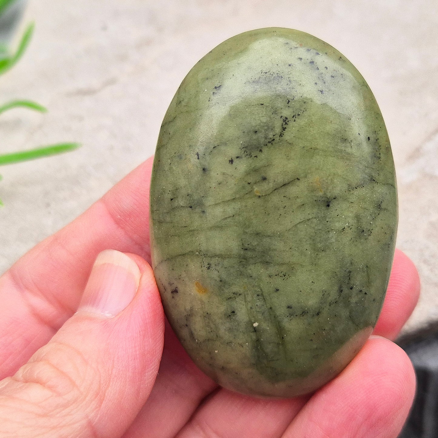 Nephrite Jade palm stone for calm, protection, and emotional balance. A soothing crystal to ease stress and support the heart. Pocket-sized. 