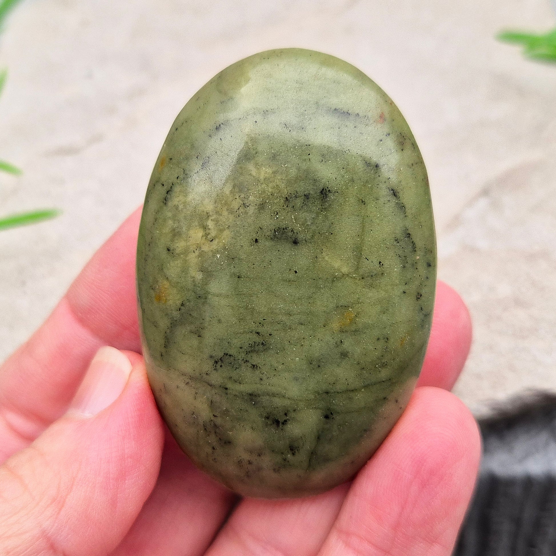 Nephrite Jade palm stone for calm, protection, and emotional balance. A soothing crystal to ease stress and support the heart. Pocket-sized. 