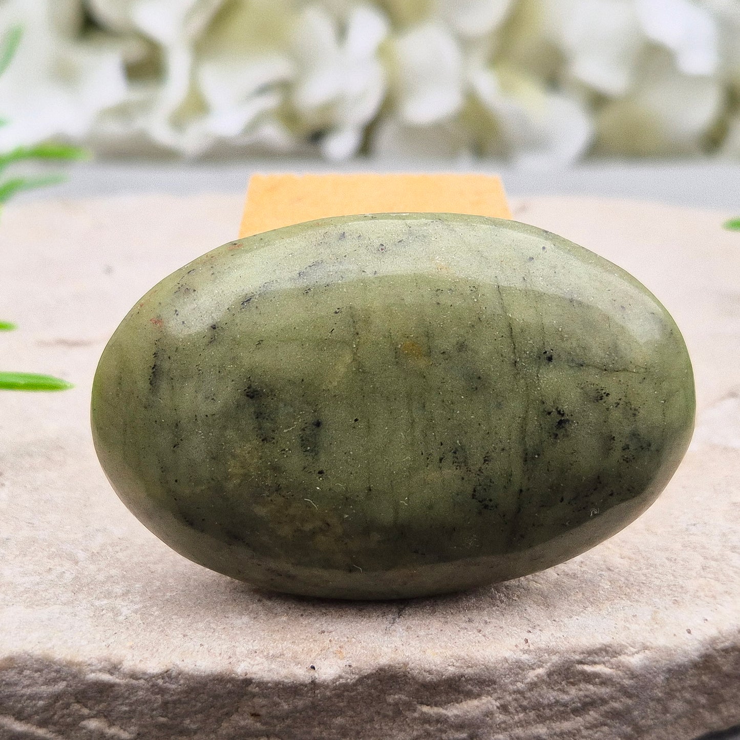 Nephrite Jade palm stone for calm, protection, and emotional balance. A soothing crystal to ease stress and support the heart. Pocket-sized. 