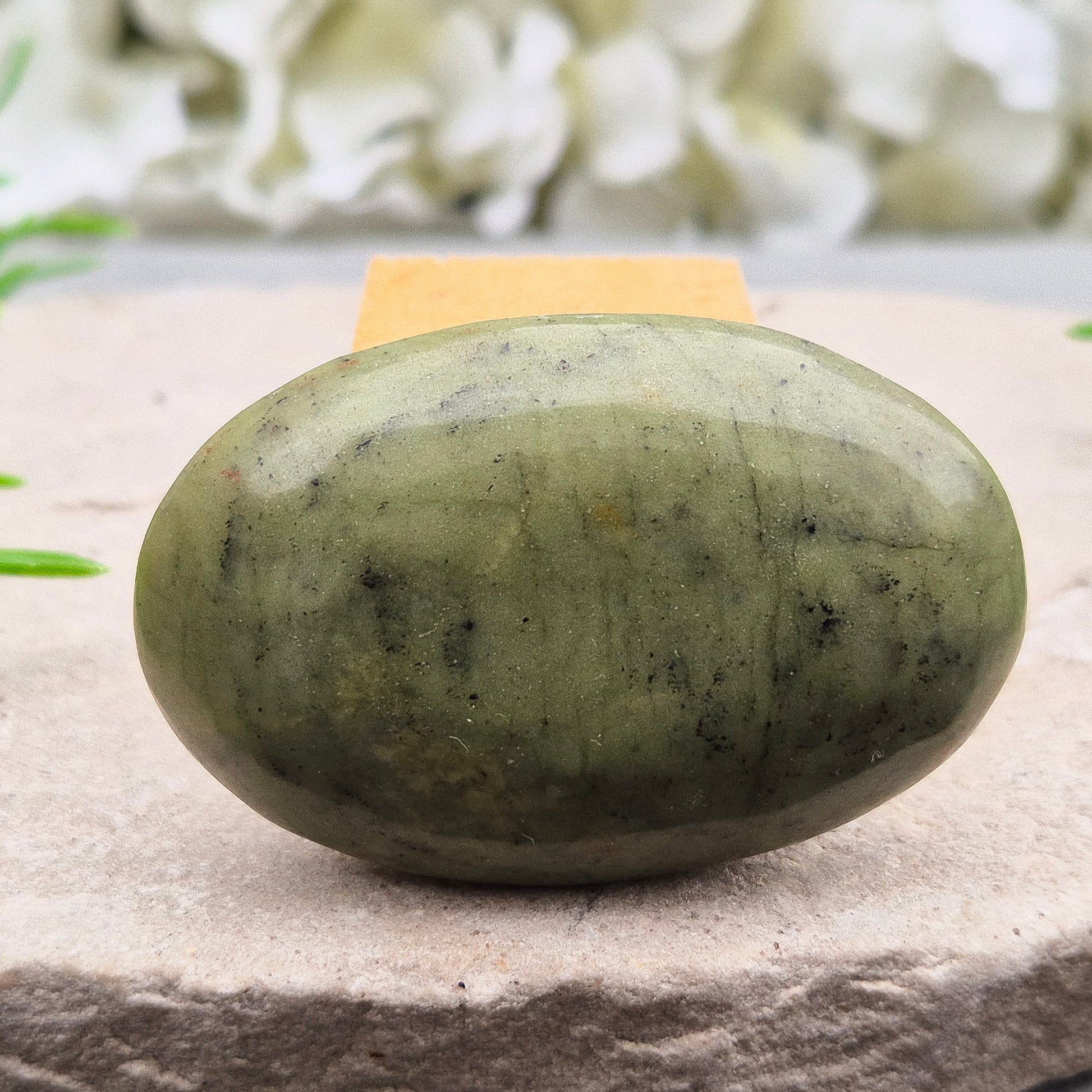 Nephrite Jade palm stone for calm, protection, and emotional balance. A soothing crystal to ease stress and support the heart. Pocket-sized. 