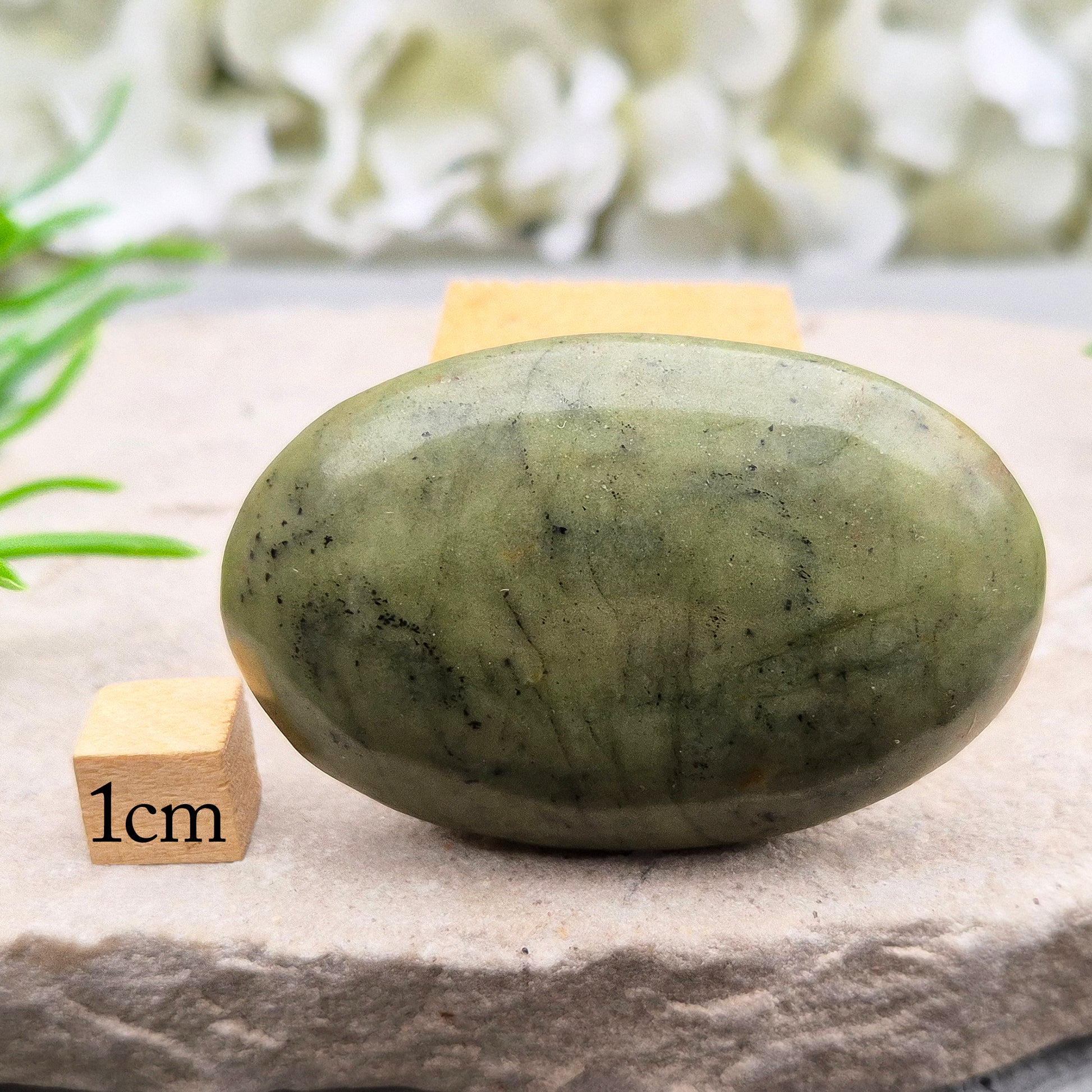 Nephrite Jade palm stone for calm, protection, and emotional balance. A soothing crystal to ease stress and support the heart. Pocket-sized. 