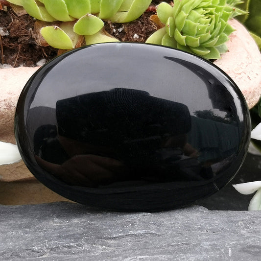Smooth Black Obsidian palm stone from Mexico. Traditionally associated with grounding, protection, and self-reflection. Ideal for everyday support.